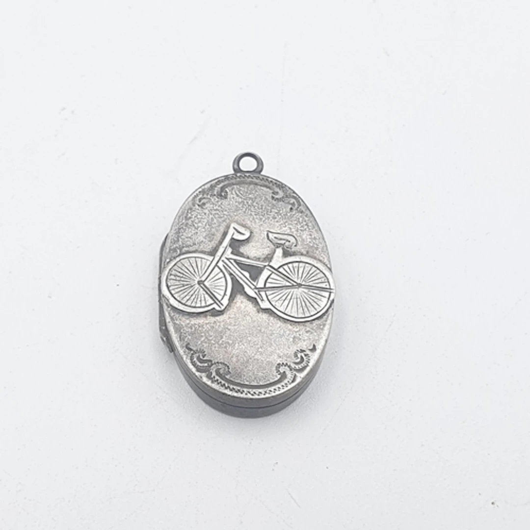 An oval silver Locket embossed bicycle to front