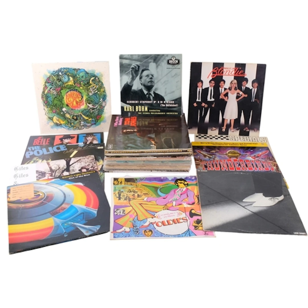 A collection of various albums, including The Jam, Wings, El...