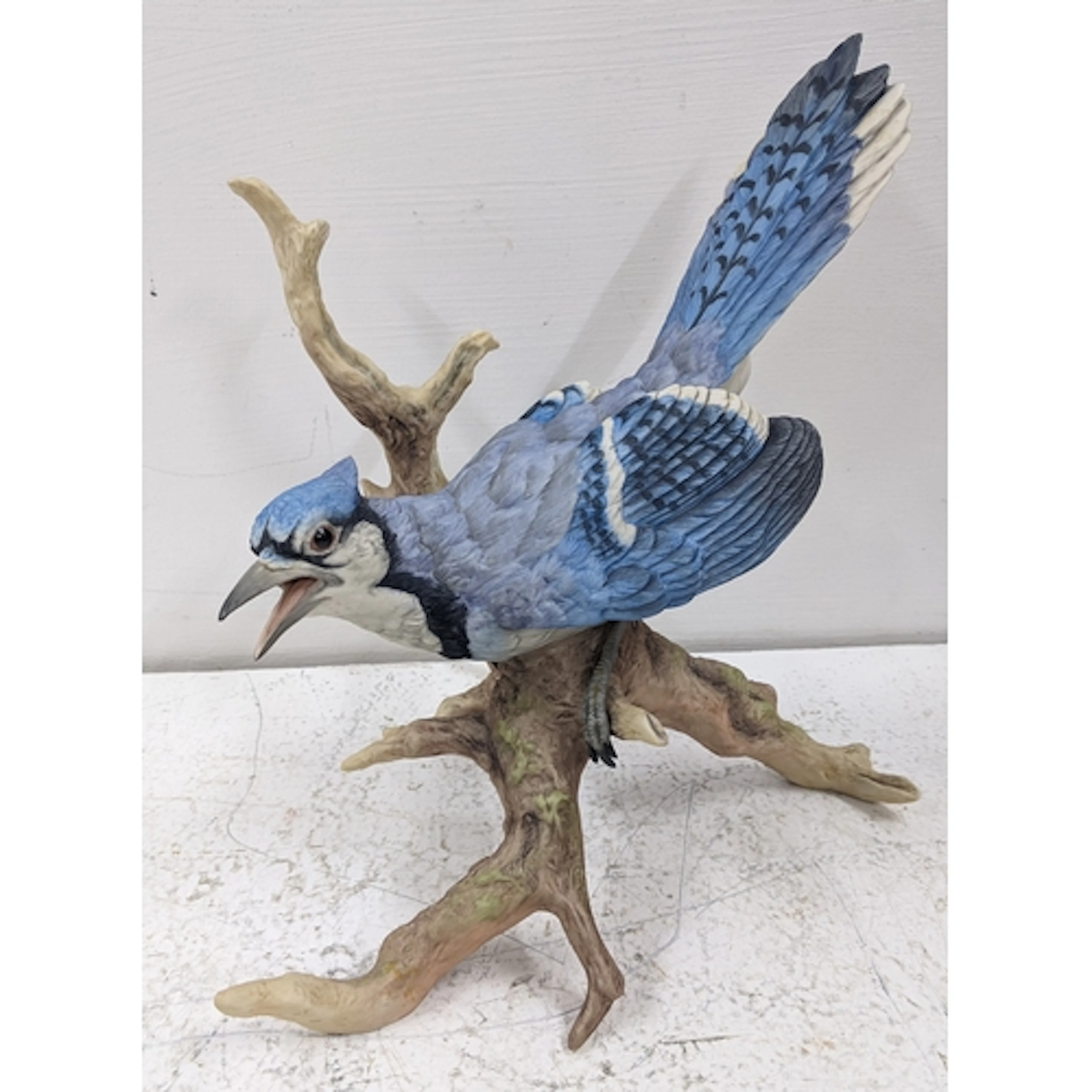 A Boehm porcelain model of a blue jay perched on a branch, 2...