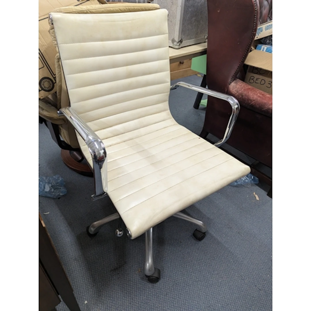 An Eames style ribbed faux leather and chrome office desk sw...