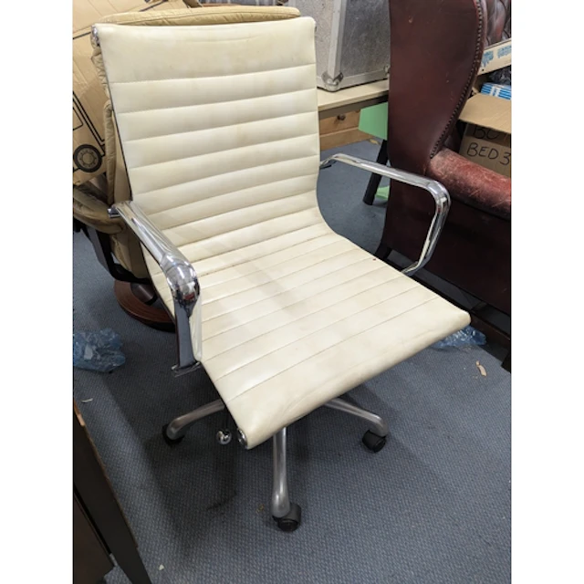 An Eames style ribbed faux leather and chrome office desk sw...