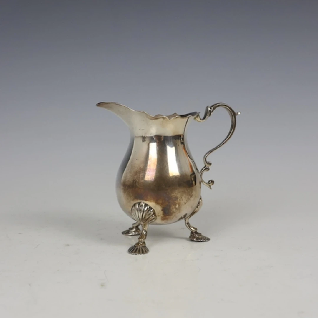 A mid 20th century silver milk jug, Lowe & Sons, Chester 196...