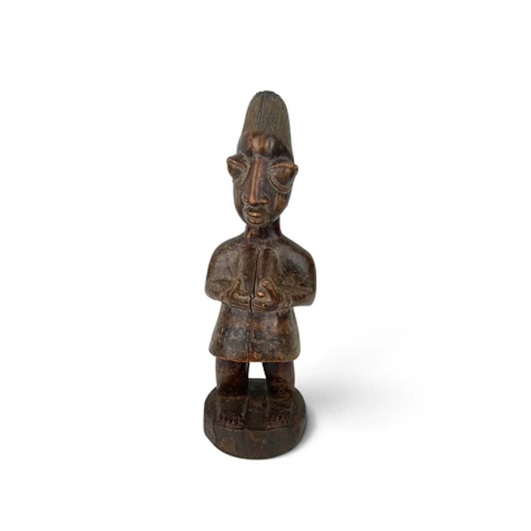 AN AFRICAN TRIBAL CARVED WOODEN SHRINE FIGURE, YORUBA In the...