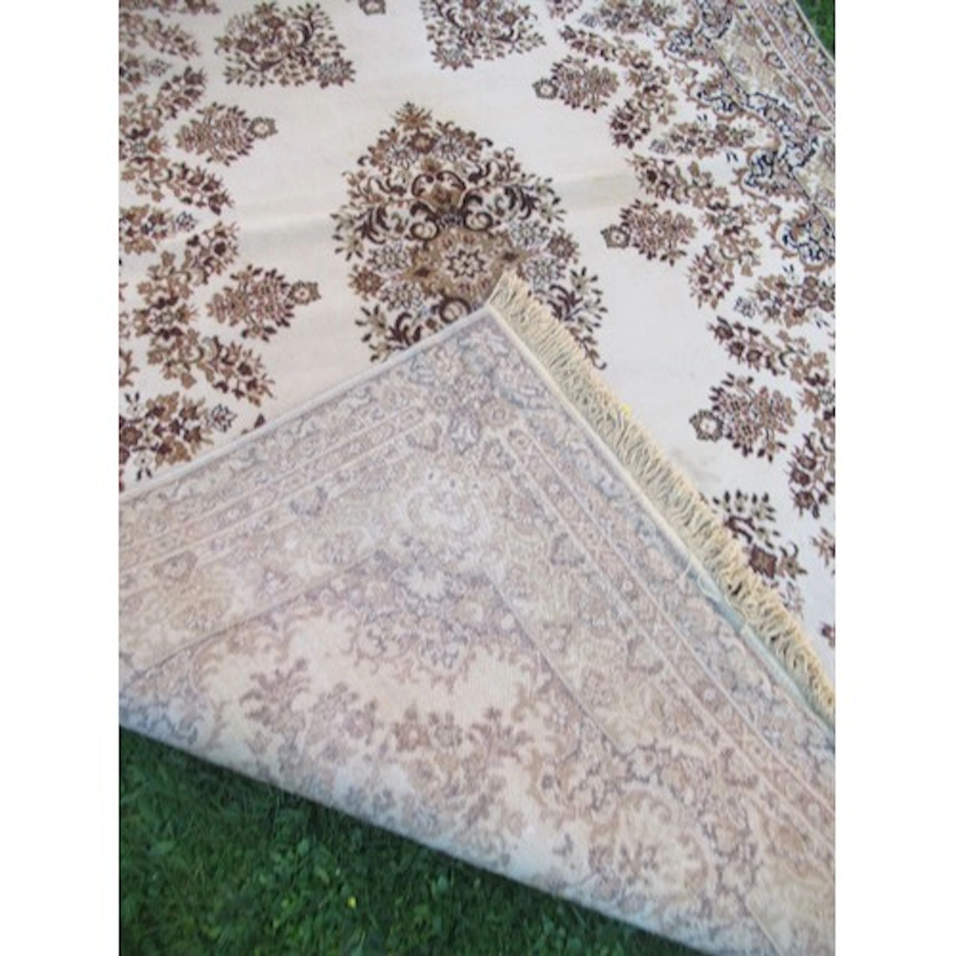 An eastern design green ground rug 116ins x 78ins