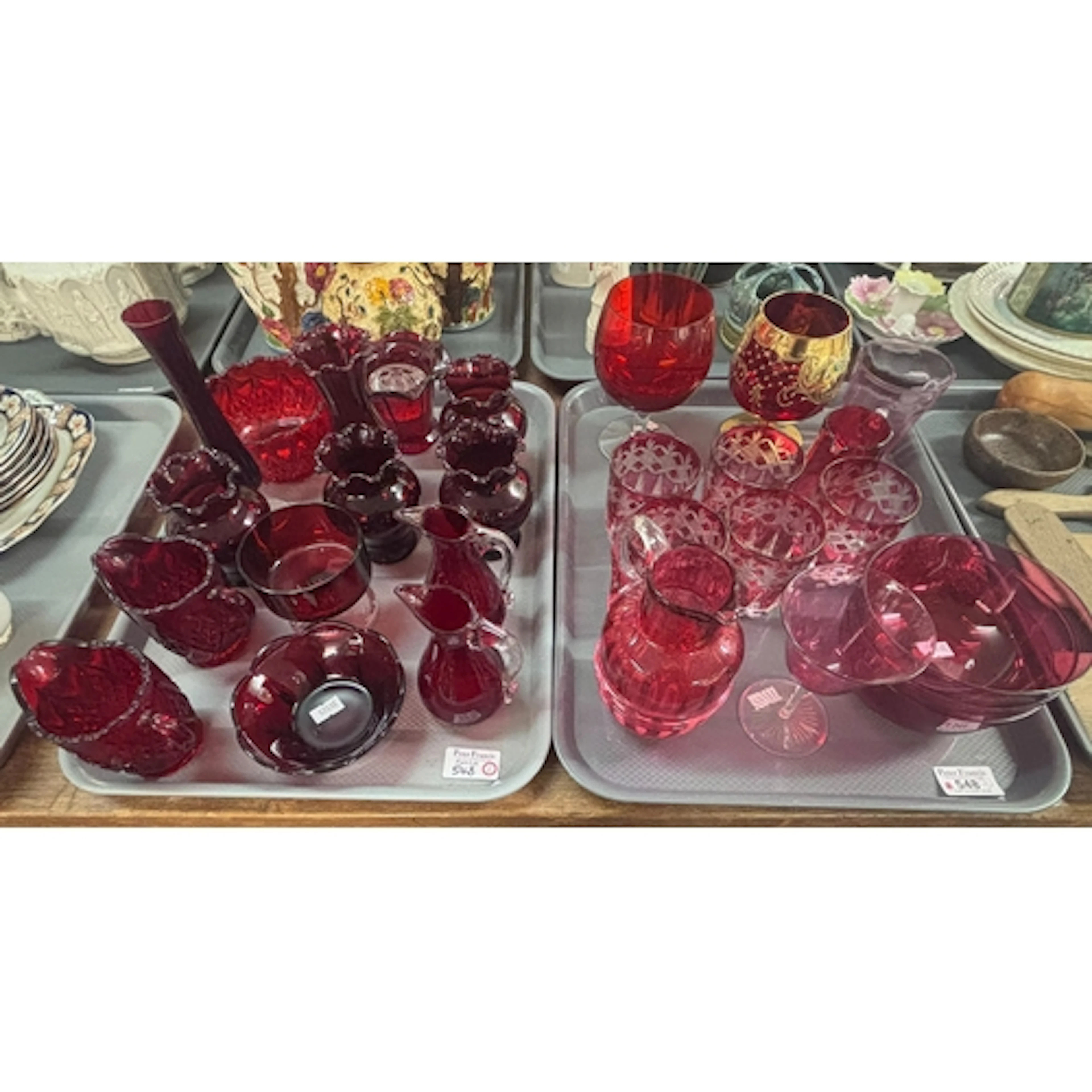 Two trays of ruby and cranberry glass items, to include flas...