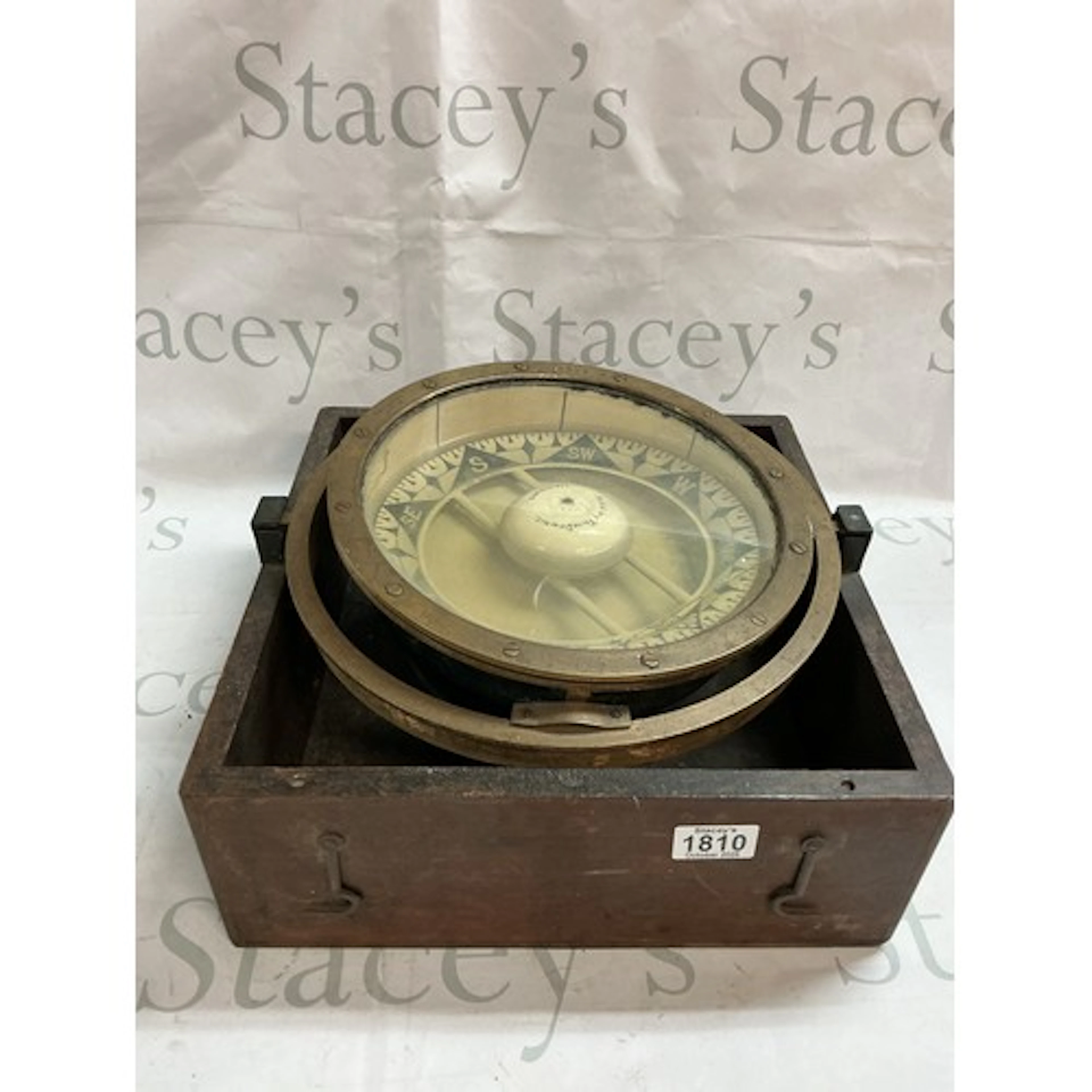 A Ships Compass in a brass gimbal.