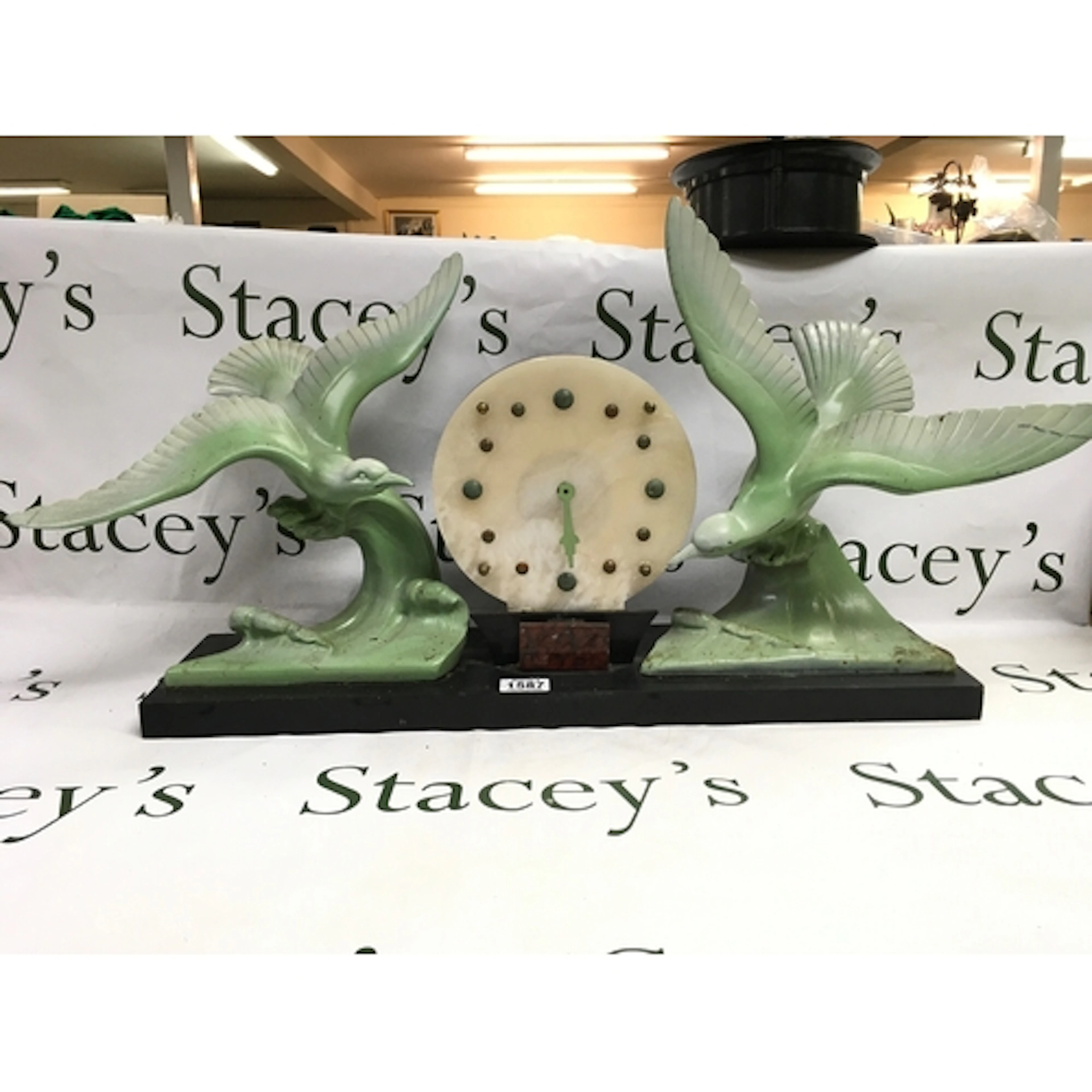 An art deco black marble mantle clock with sculptured bird g...