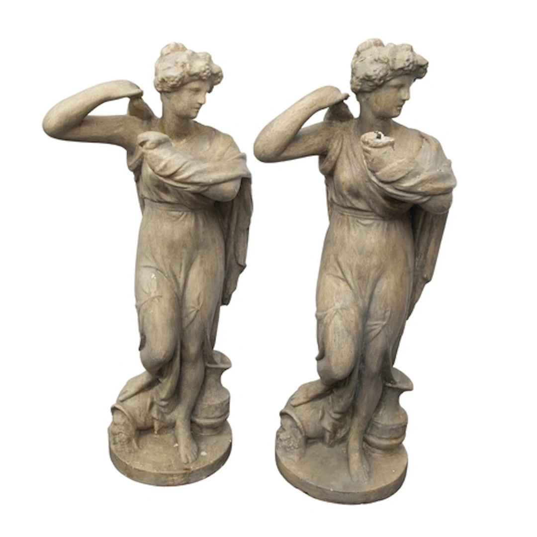 A pair of painted plaster figural torchere stands in the man...