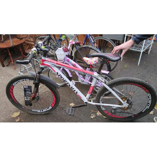 Sportsman mountain bicycle with a white and red frame, front...
