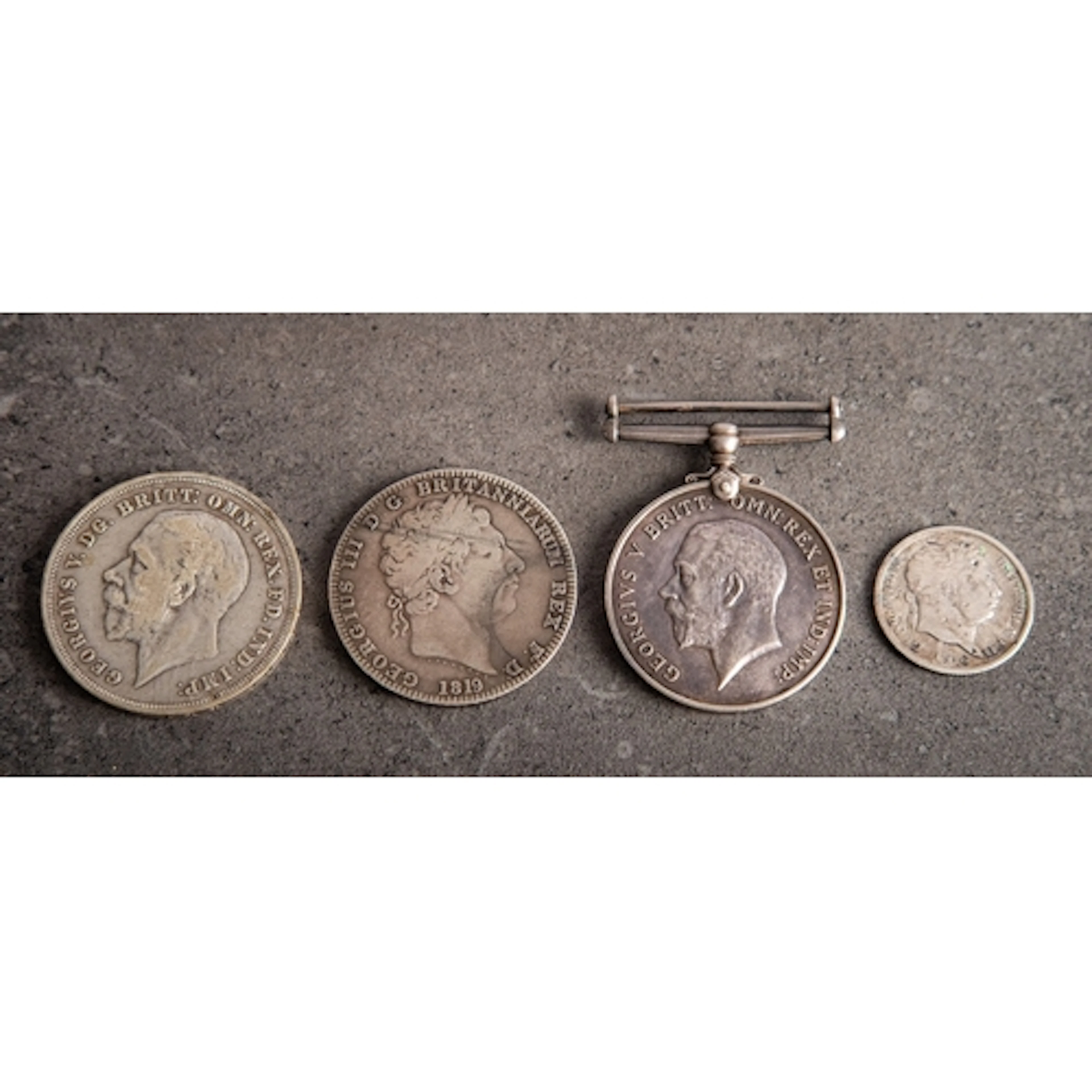 An 1819 George III Crown coin. Together with a 1935 Crown, a...