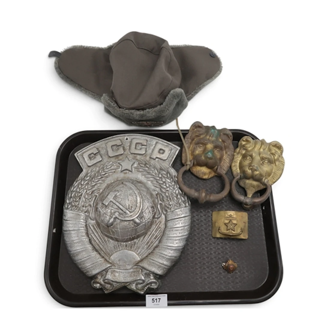 A Soviet cast metal wall plaque, ushanka hat and naval belt ...