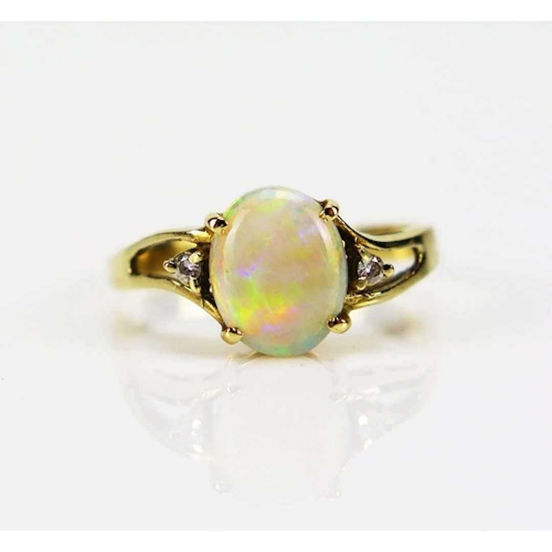 A singlet opal and diamond ring in a 14ct yellow gold settin...