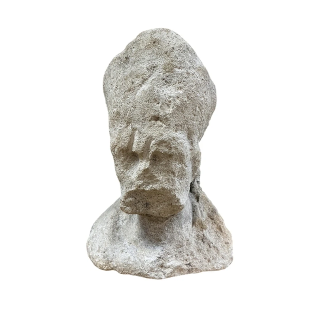 An antique weathered stone bust, possibly depicting a bishop...