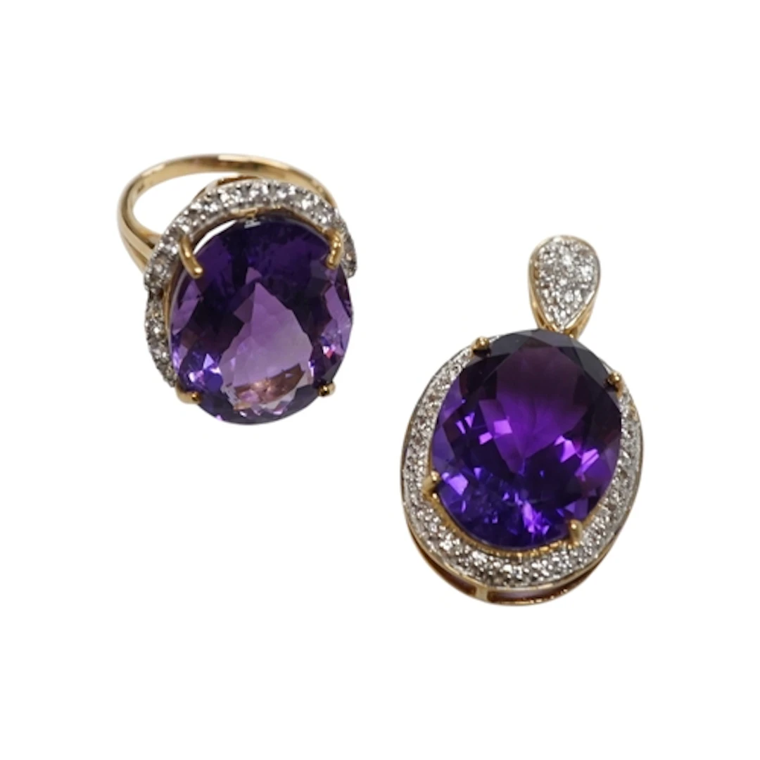 An amethyst pendant and ring, each set with an oval amethyst...