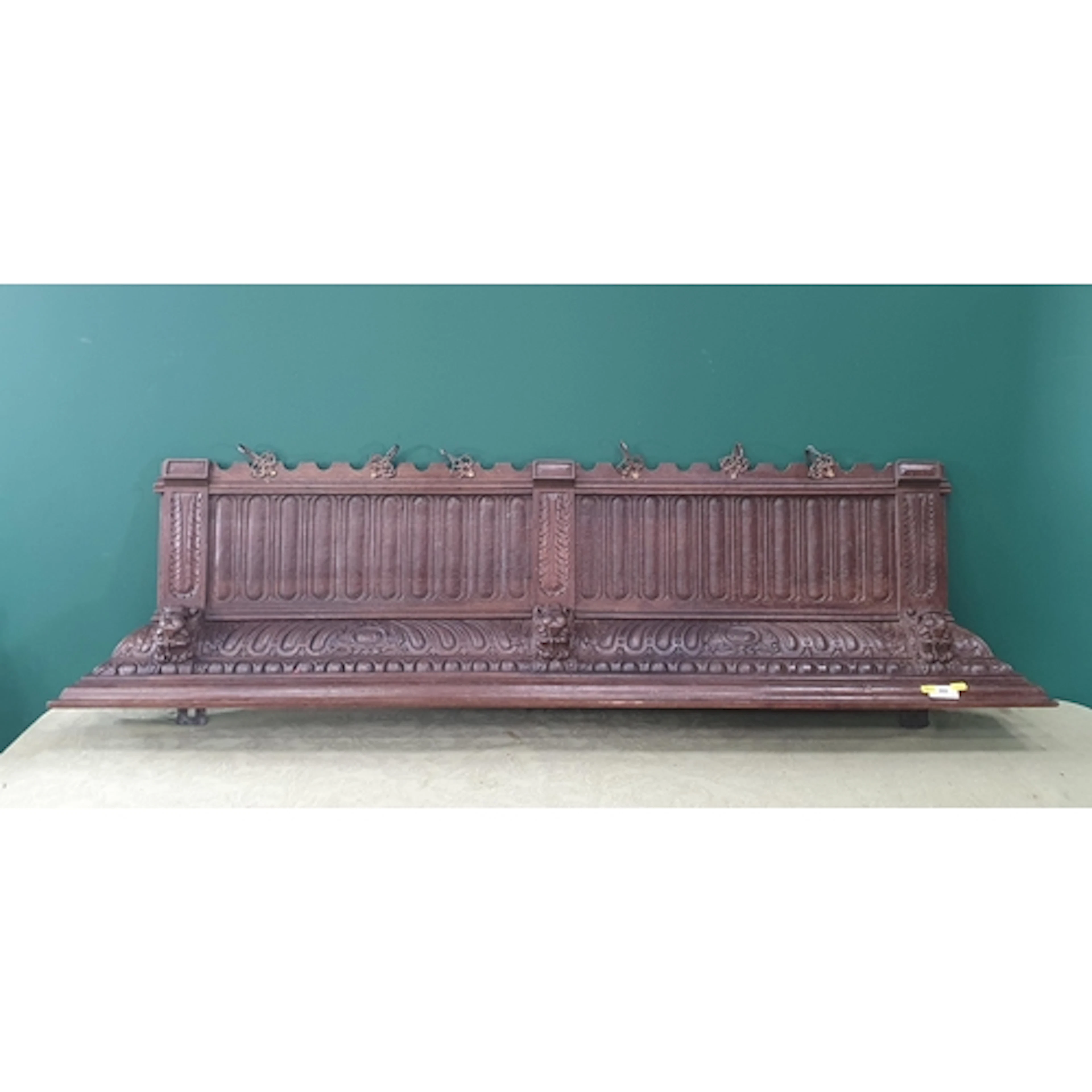 An antique carved oak Hall Bracket, carved masks and mounted...