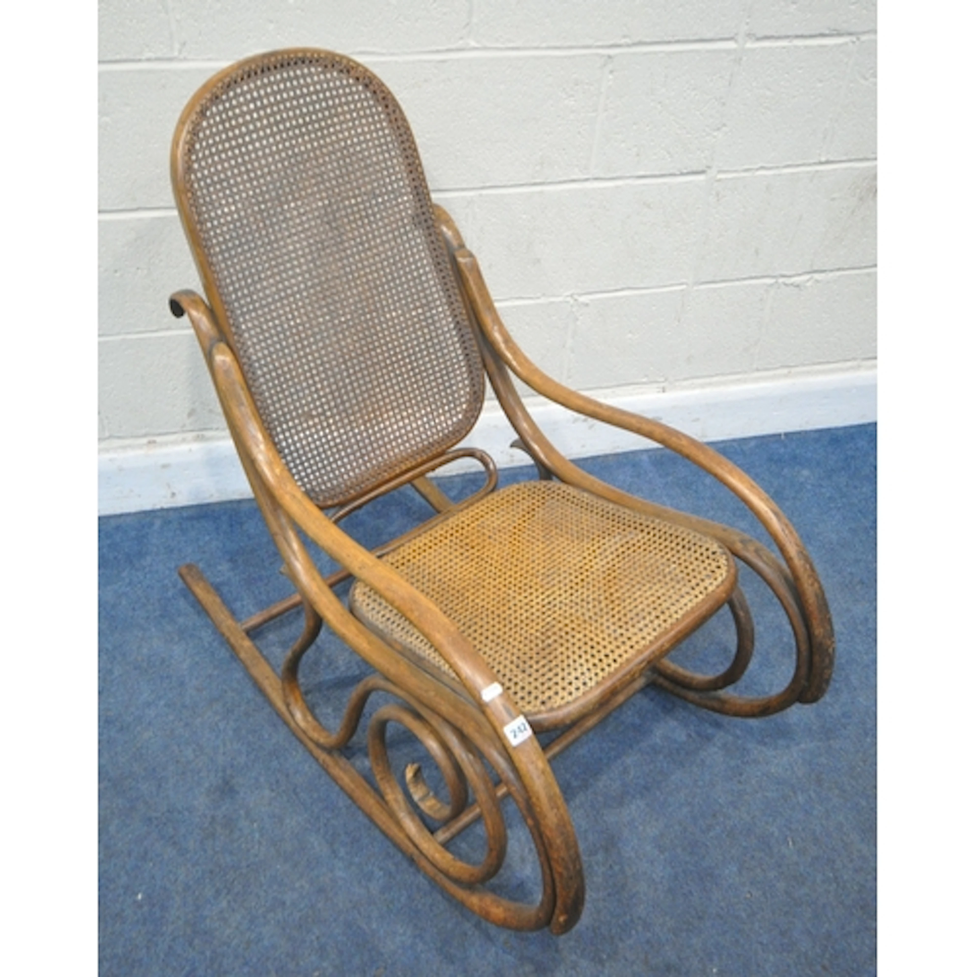 AFTER MICHAEL THONET, A BENTWOOD ROCKING ARMCHAIR, with cane...