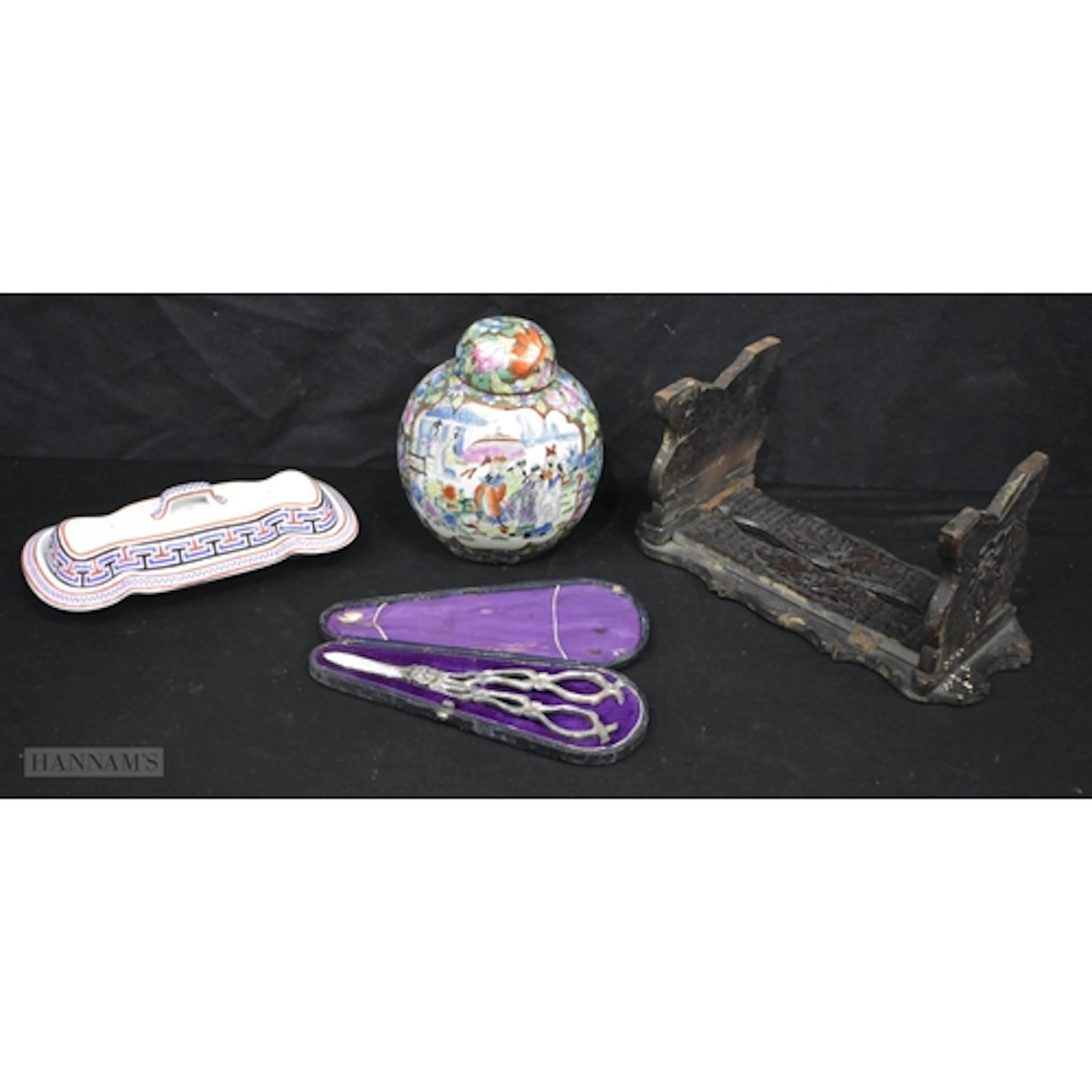 An early 20th Century carved wood stand together with a Cope...