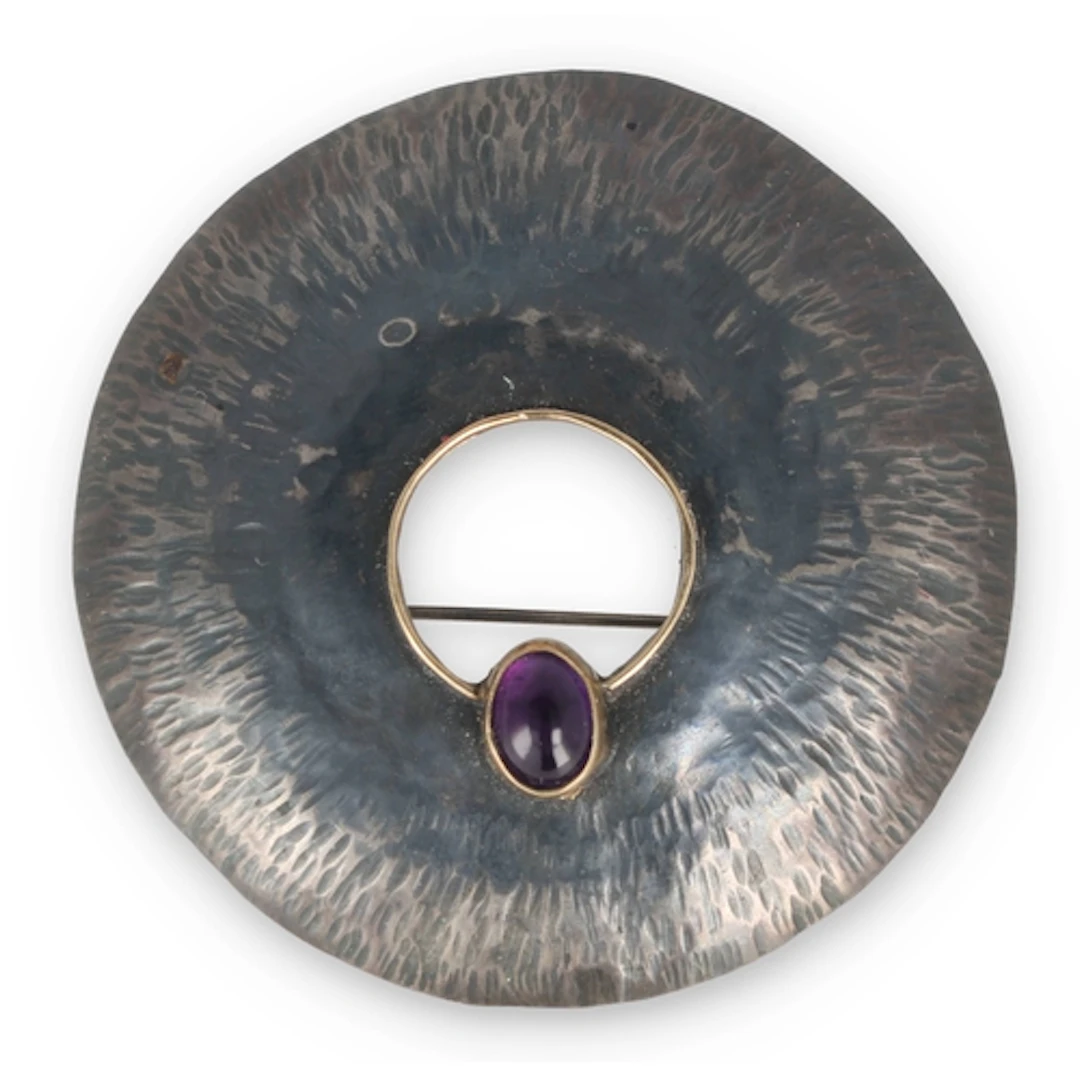A SILVER, GOLD MOUNTED AND AMETHYST BROOCH Weight: 12.9gms ...