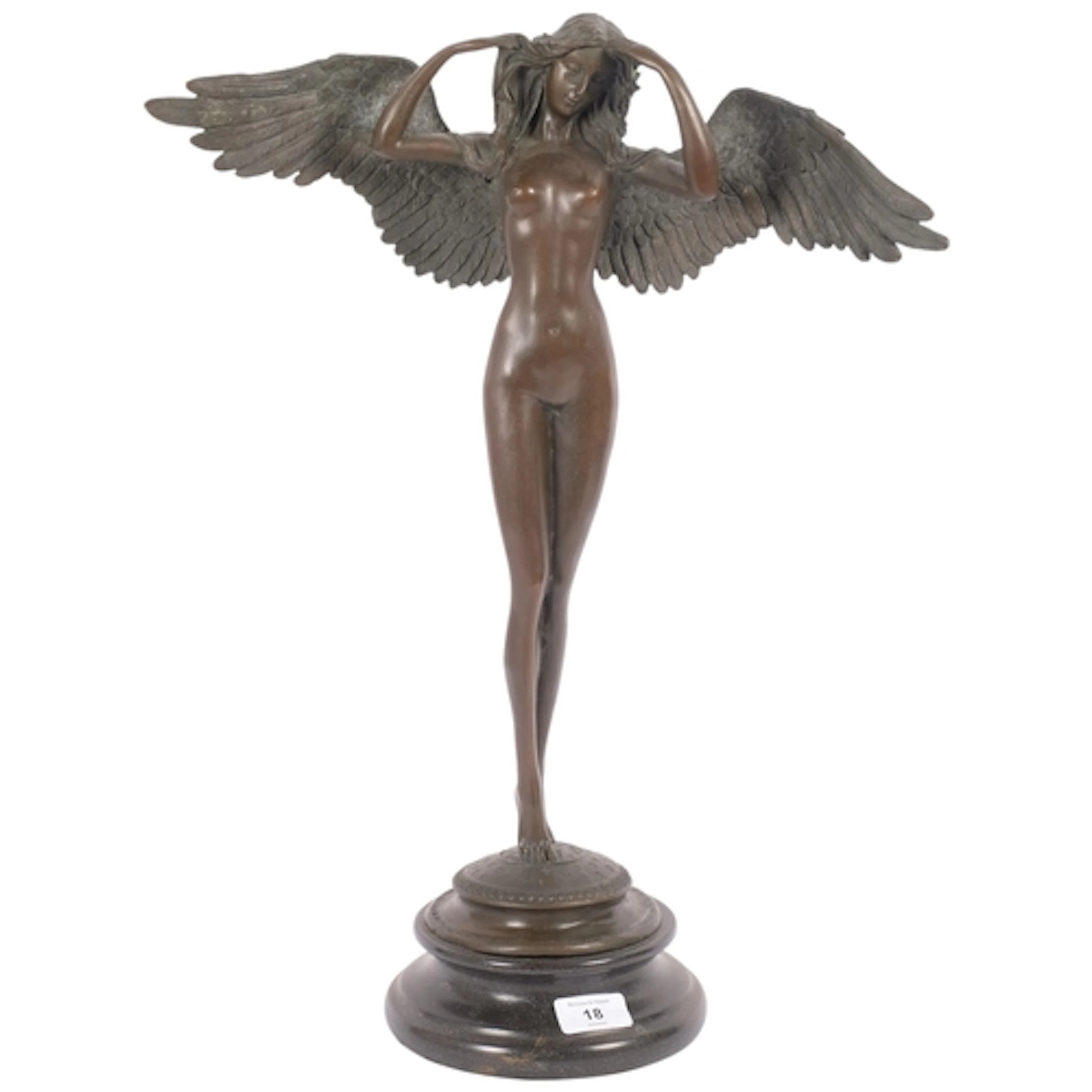 A reproduction bronze sculpture of an angel on circular marb...