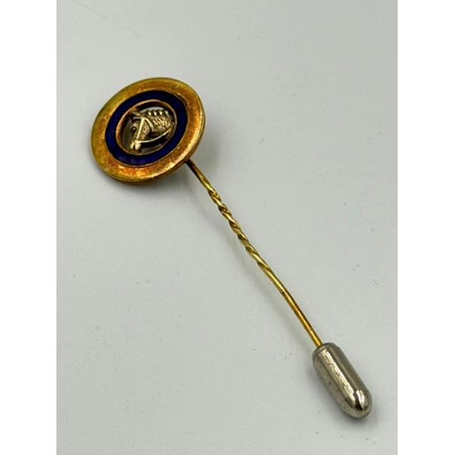 A gold and enamel horse racing lapel pin
