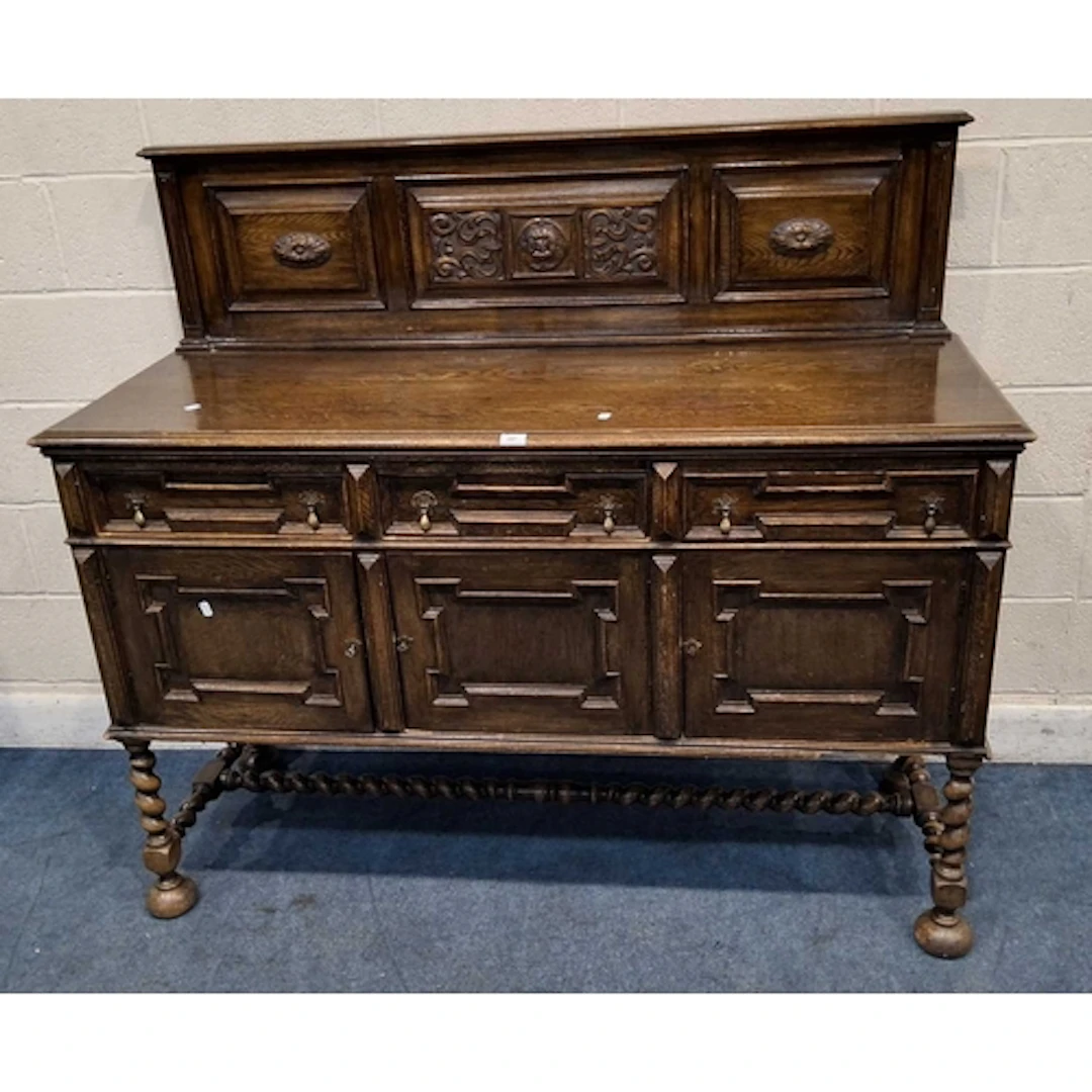 AN EARLY 20TH CENTURY OAK SIDEBOARD, with a raised back, fit...