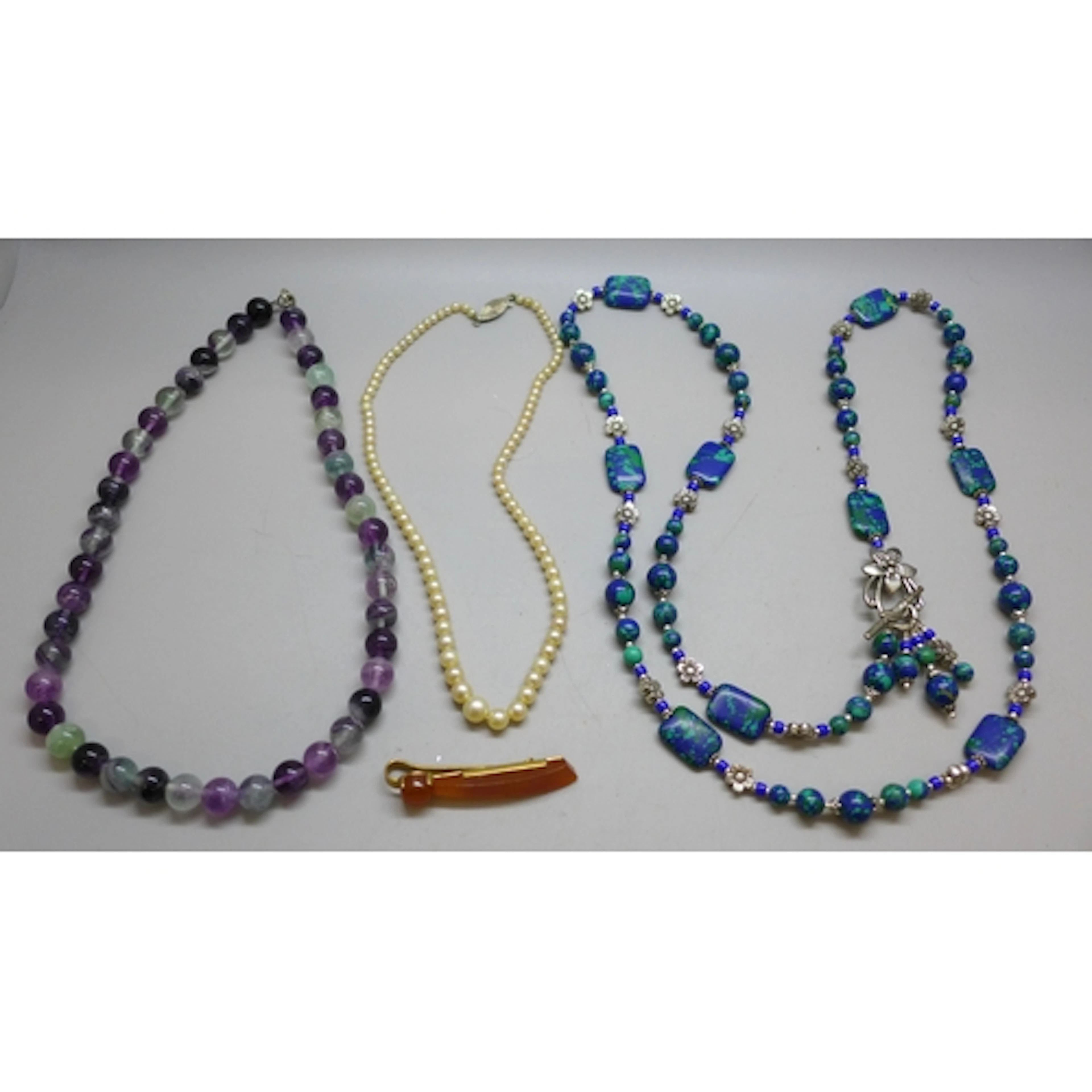 Necklaces including fluorite, and an amber style clip