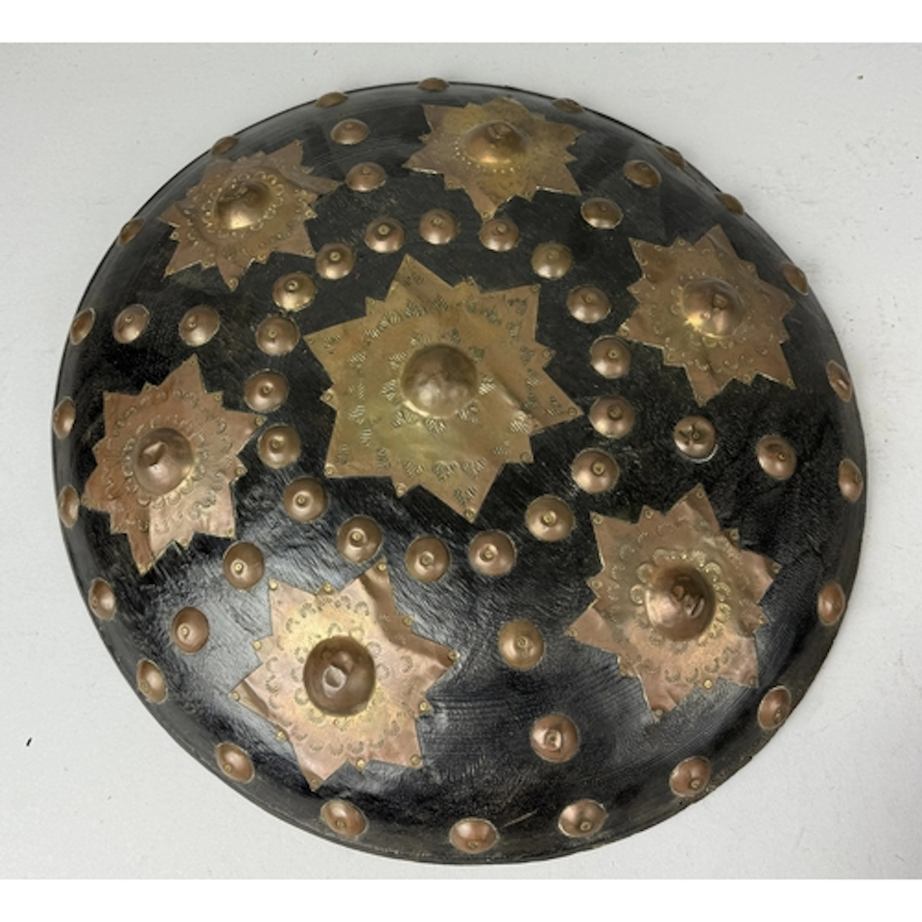 AN INDONESIAN SHIELD OR BUCKLER, WOOD WITH APPLIED BRASS ORN...