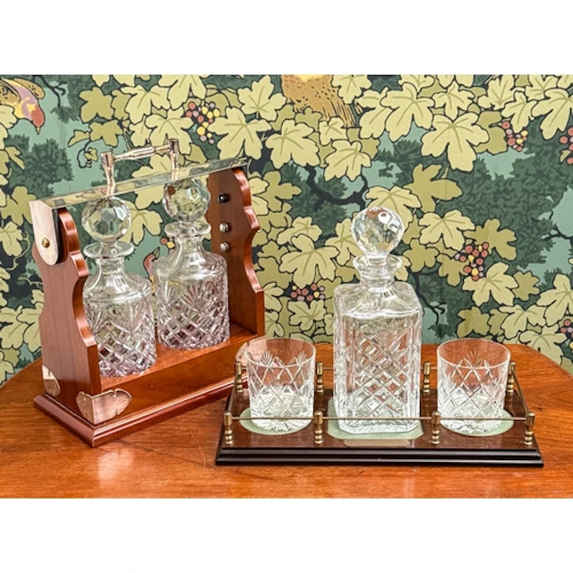 A modern wood and silver plated tantalus housing two decante...