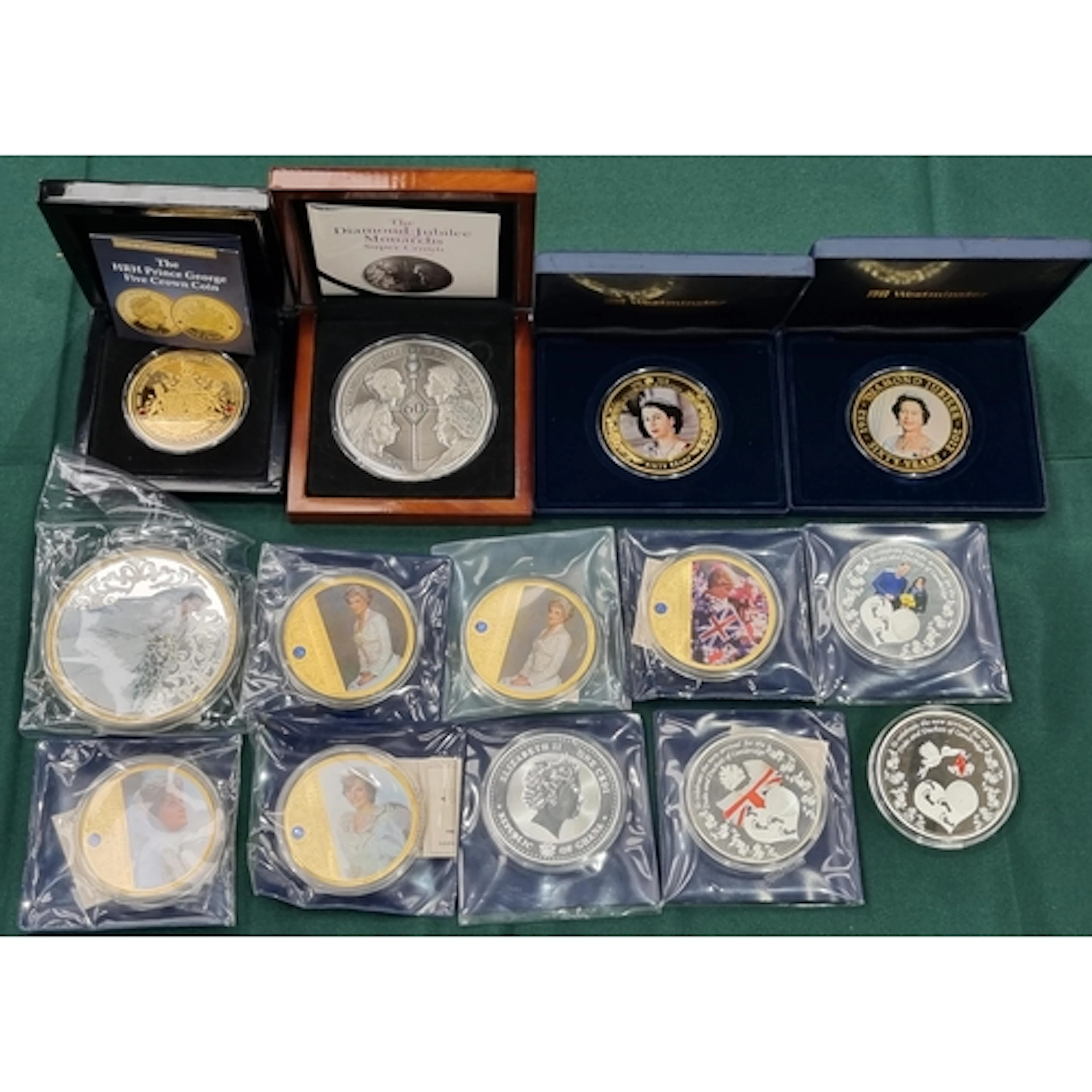 A collection of oversized medallic Coins, to include a Trist...
