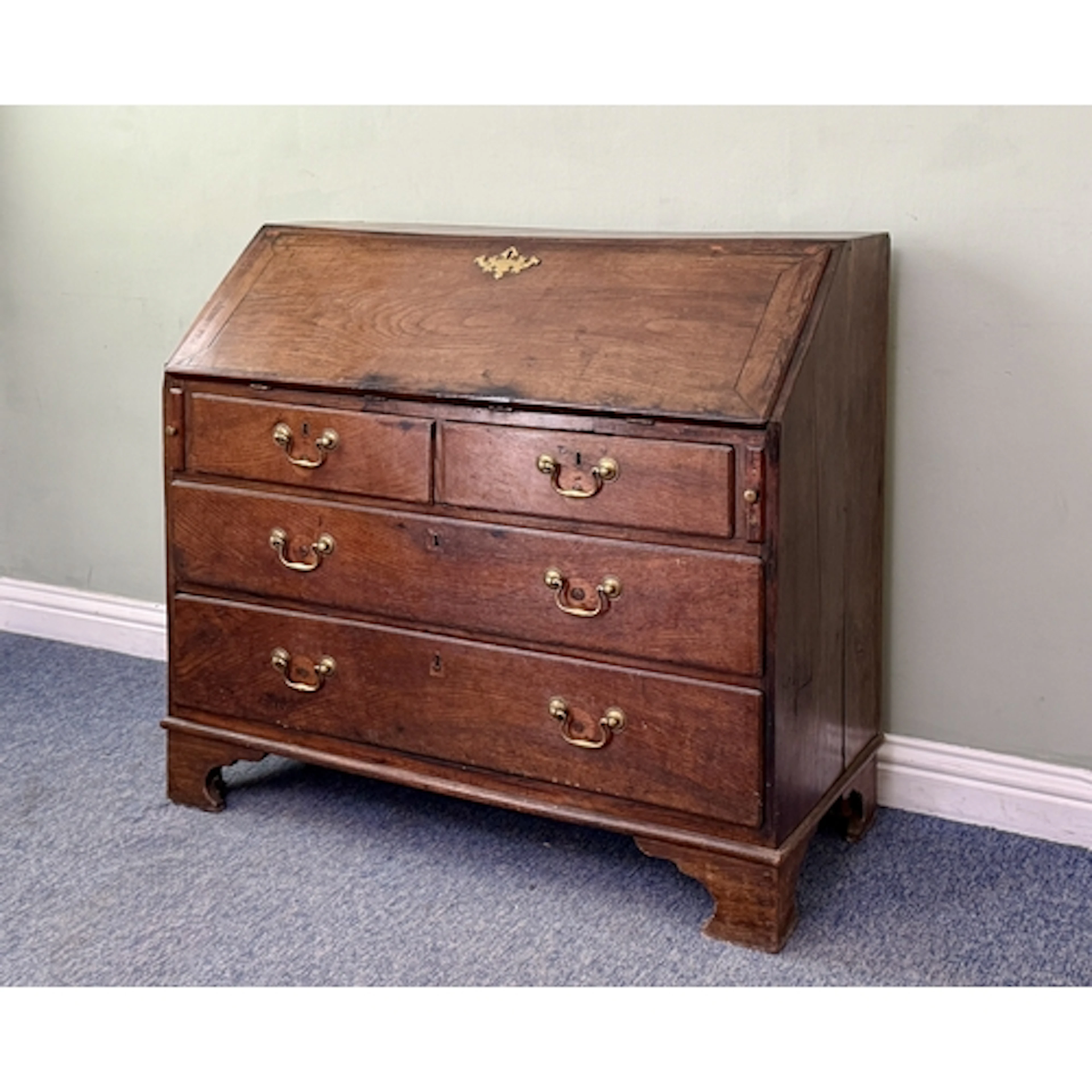 A George III oak bureau - the fitted interior with an arrang...