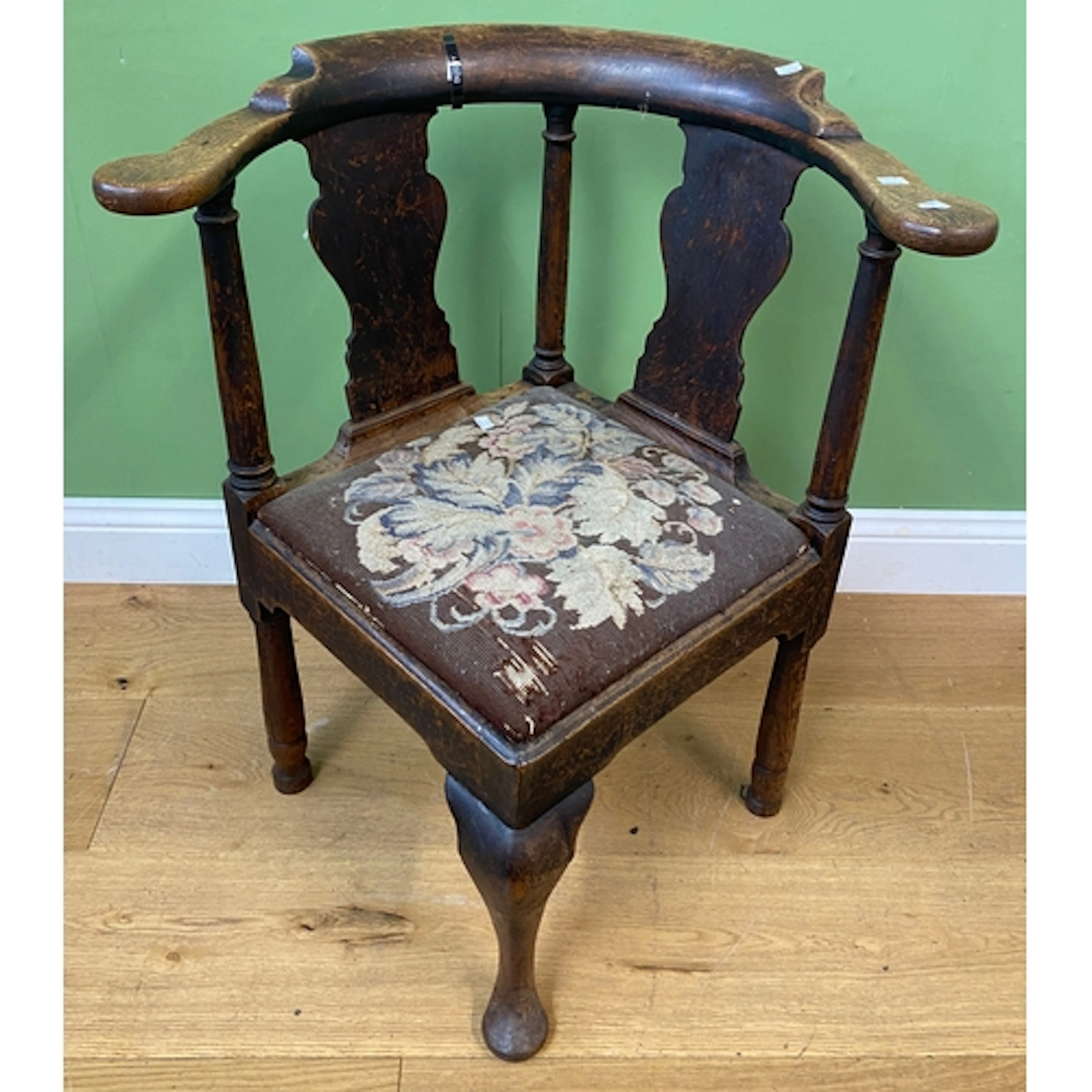 An 18th century oak splatback corner chair with shaped colla...