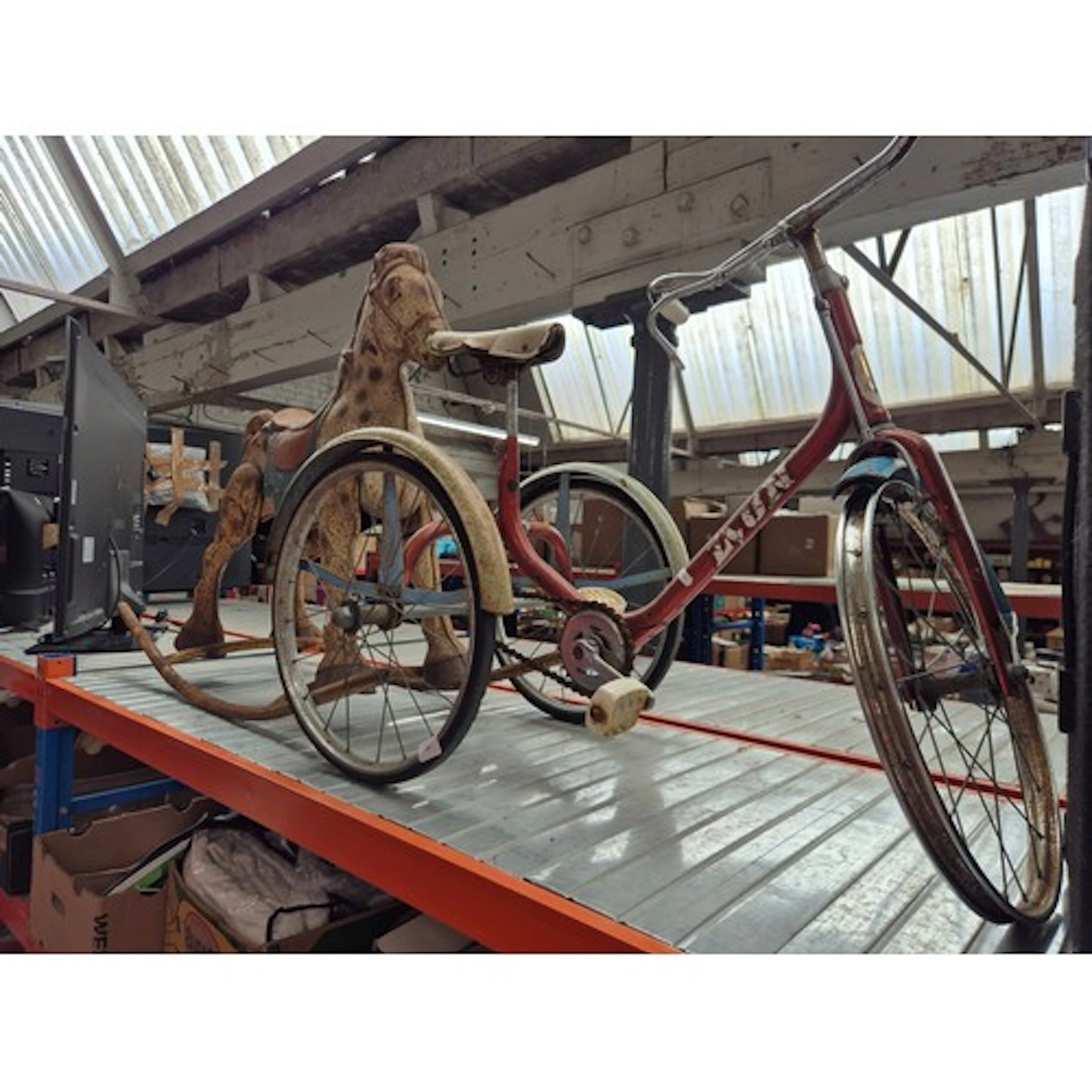 A metal child's rocking horse together with a child's Tricyc...