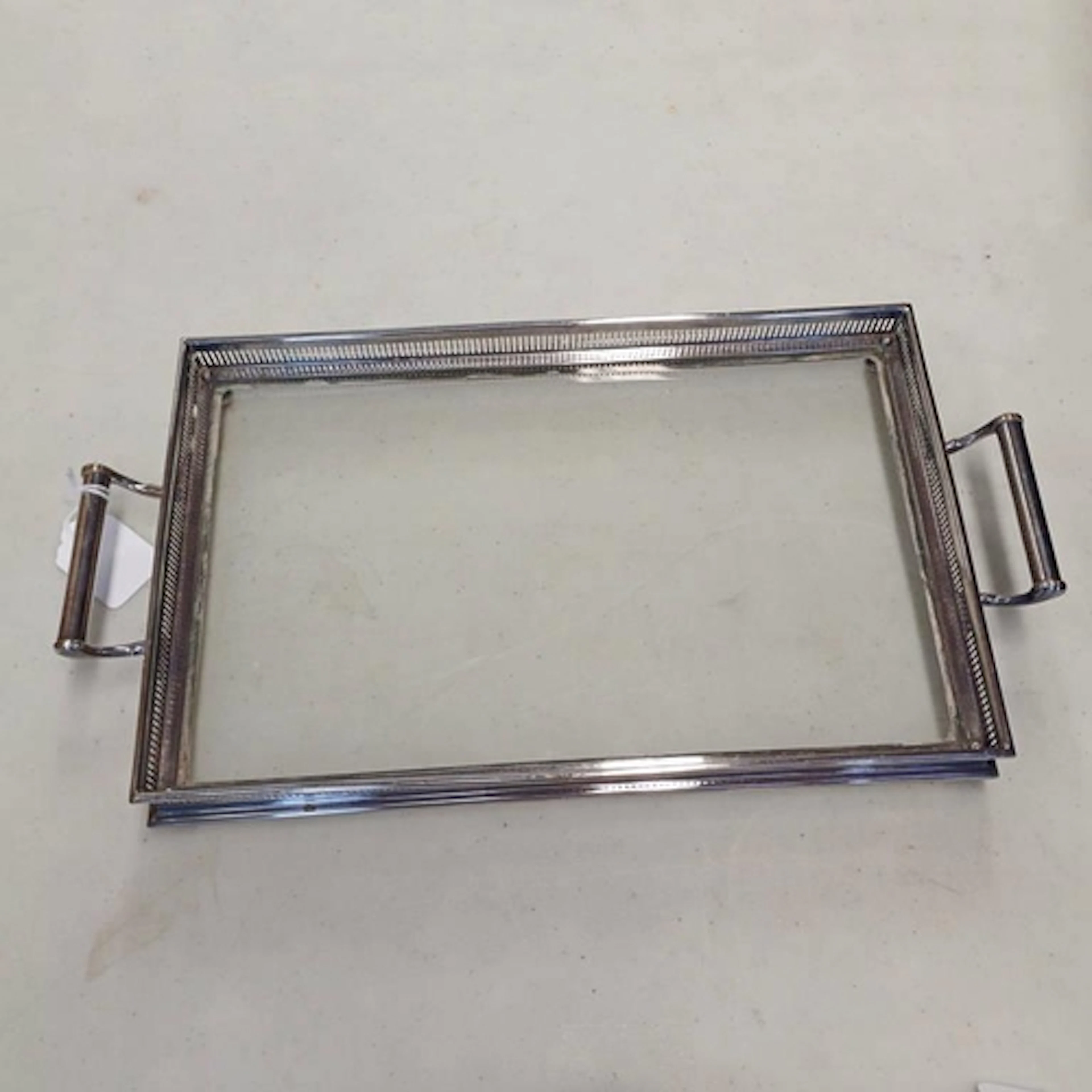 A SILVER PLATE & GLASS 2 HANDLED TRAY WITH PIERCED BORDER ON...