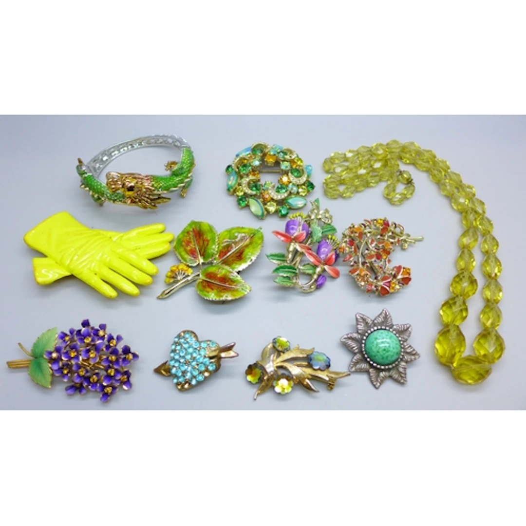 A collection of costume jewellery including an enamel dragon...