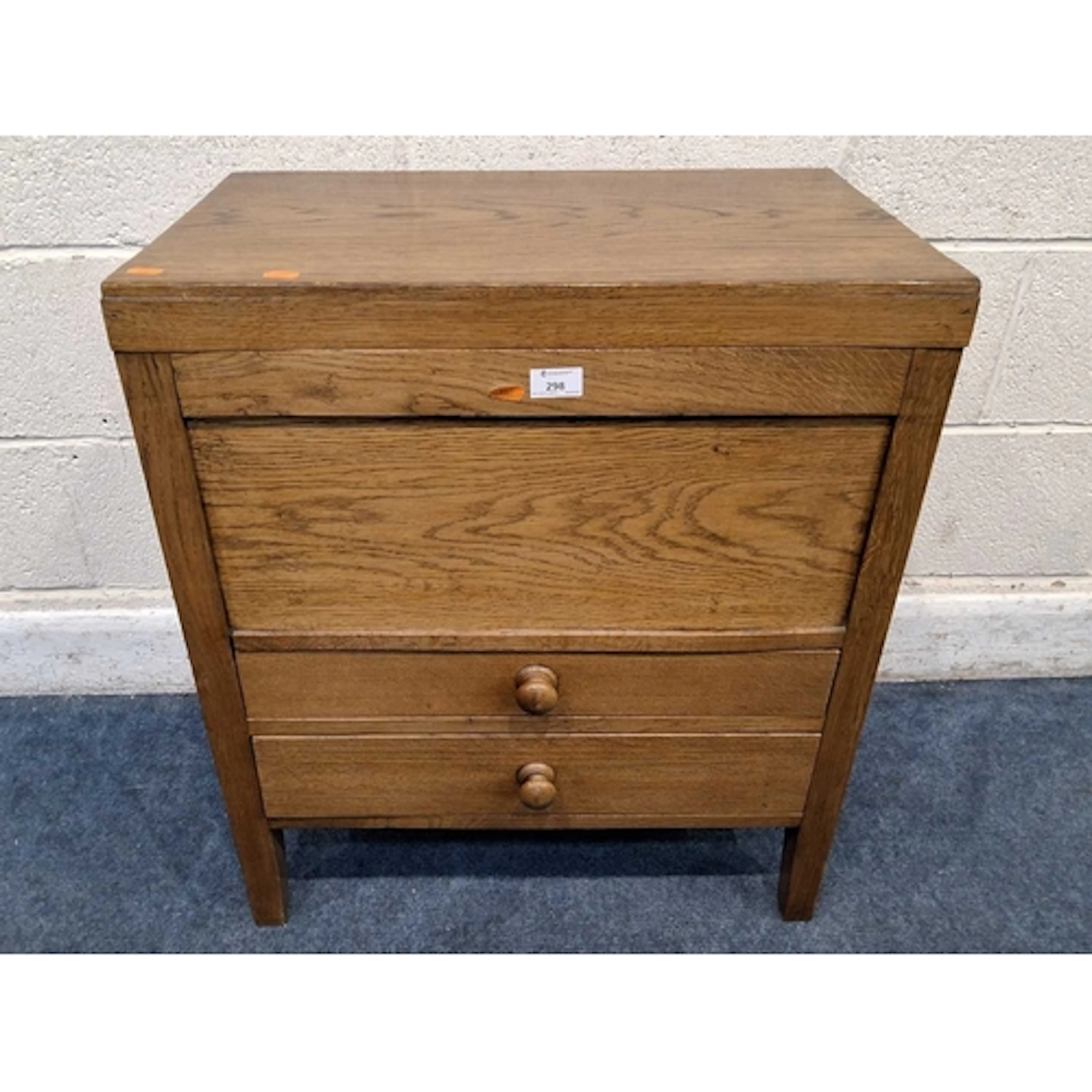 AN EARLY 20TH CENTURY OAK CABINET, with a hinged lid and two...