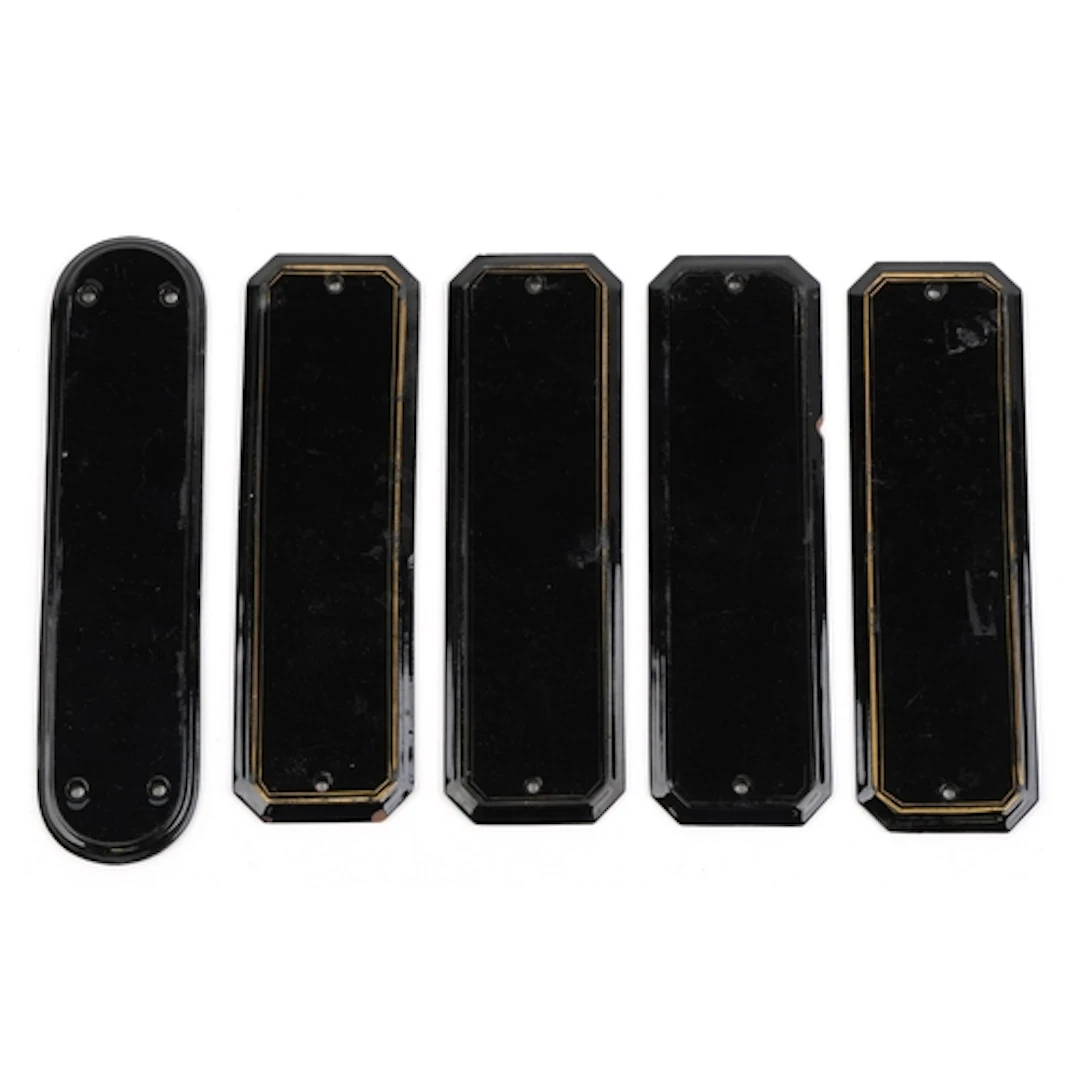 Five Victorian black glazed terracotta door plates, each bea...