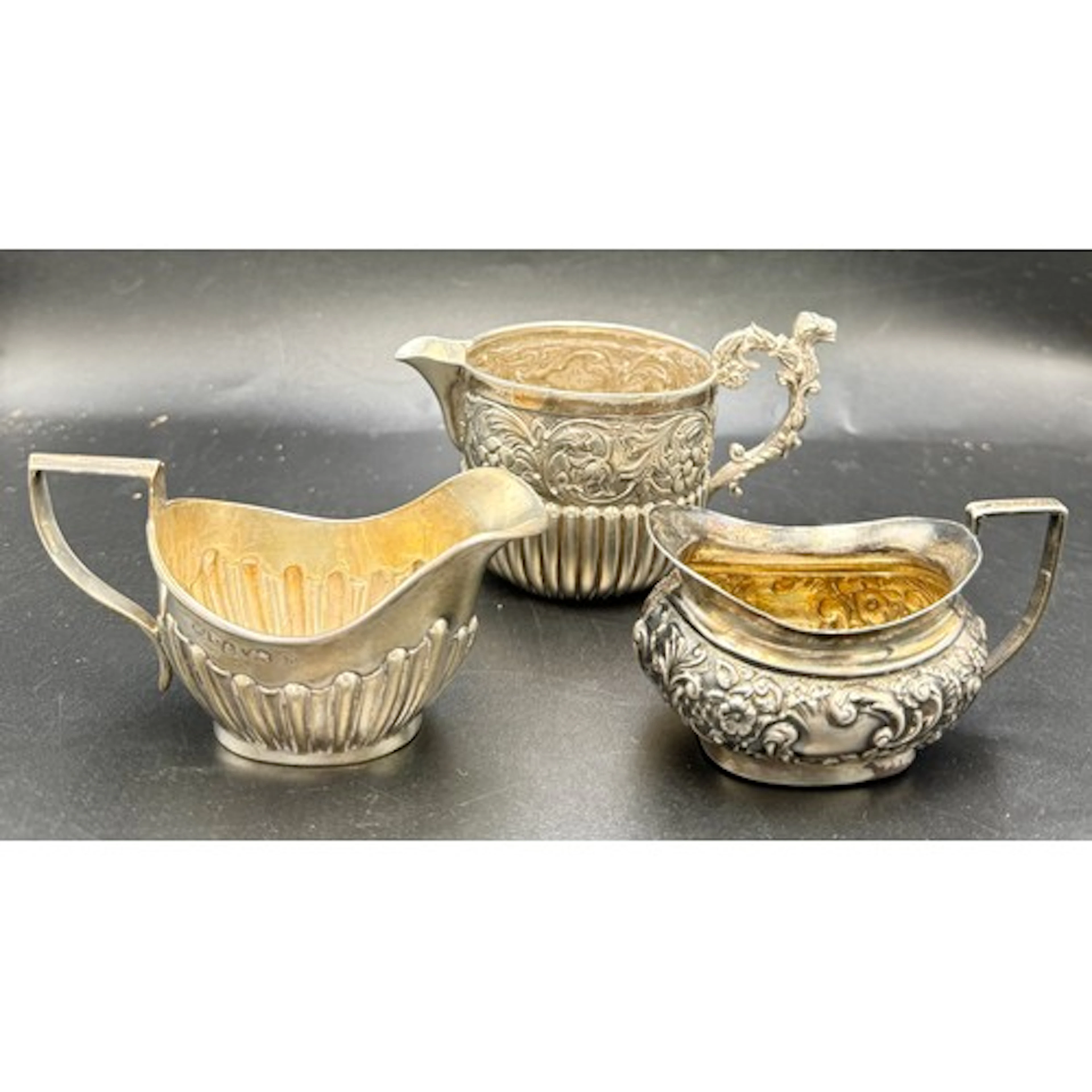 Three silver jugs to include Birmingham 1901, maker William ...