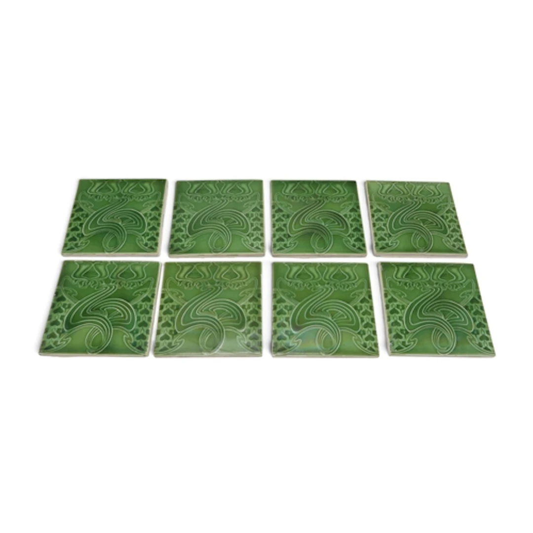 A set of eight English made Art Nouveau tiles, each green gl...