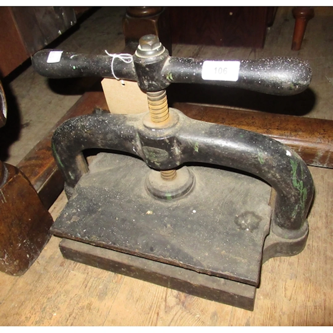 Antique cast iron book press, 42cm wide, together with a vin...