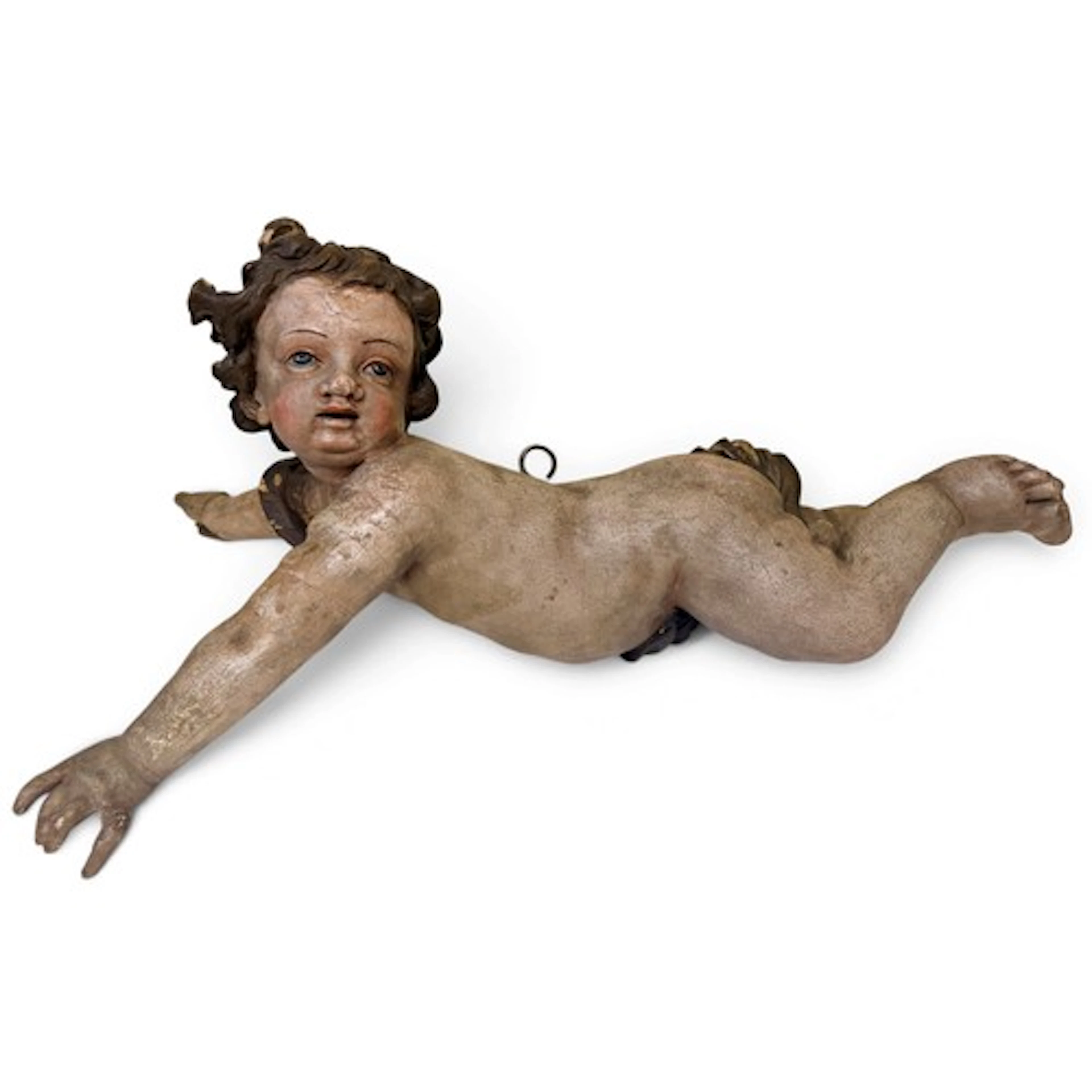 A large carved and painted gesso model of a putto or cherub ...