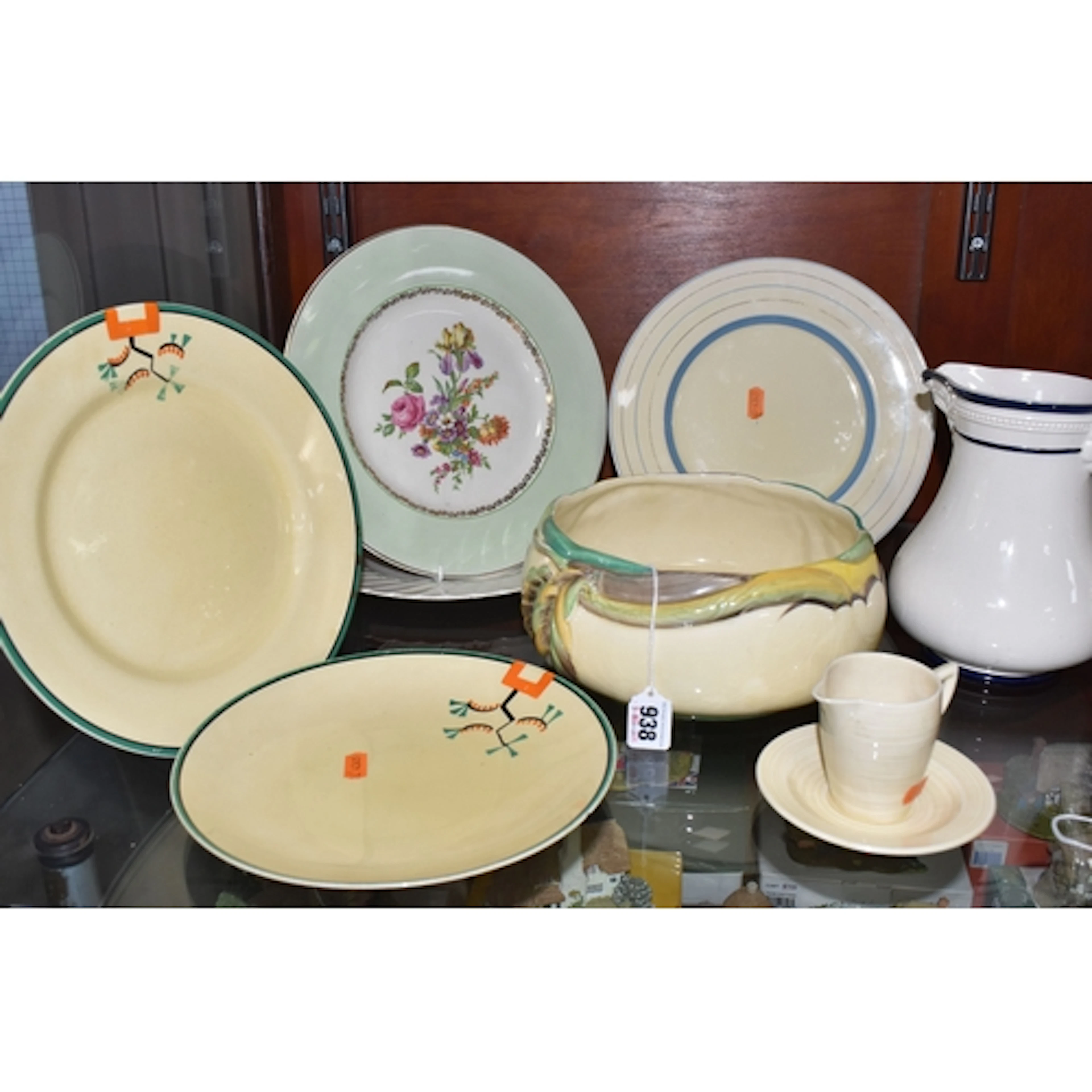 A GROUP OF NINE PIECES OF CLARICE CLIFF CERAMICS, comprising...