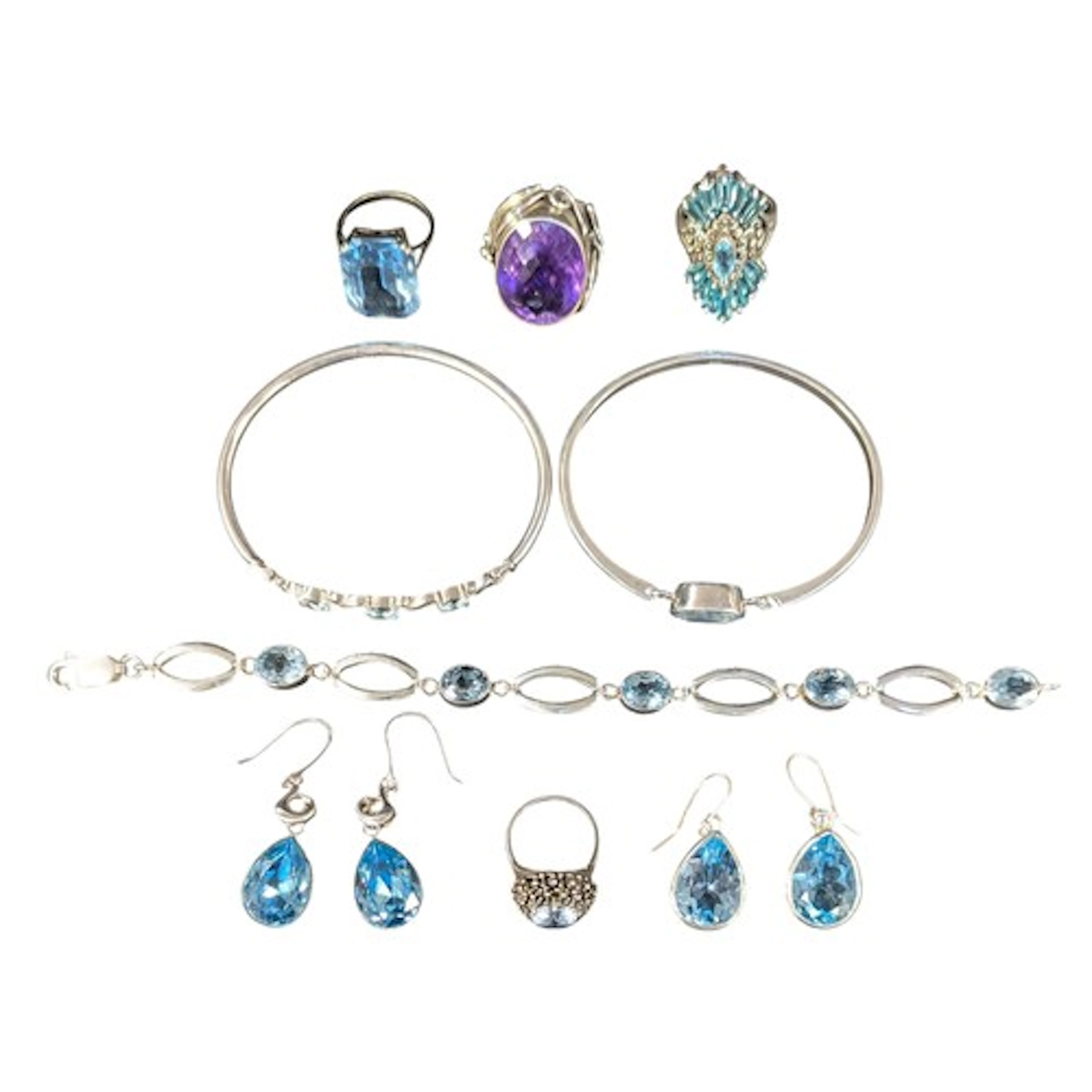A silver and pale blue topaz spring action bangle, another t...