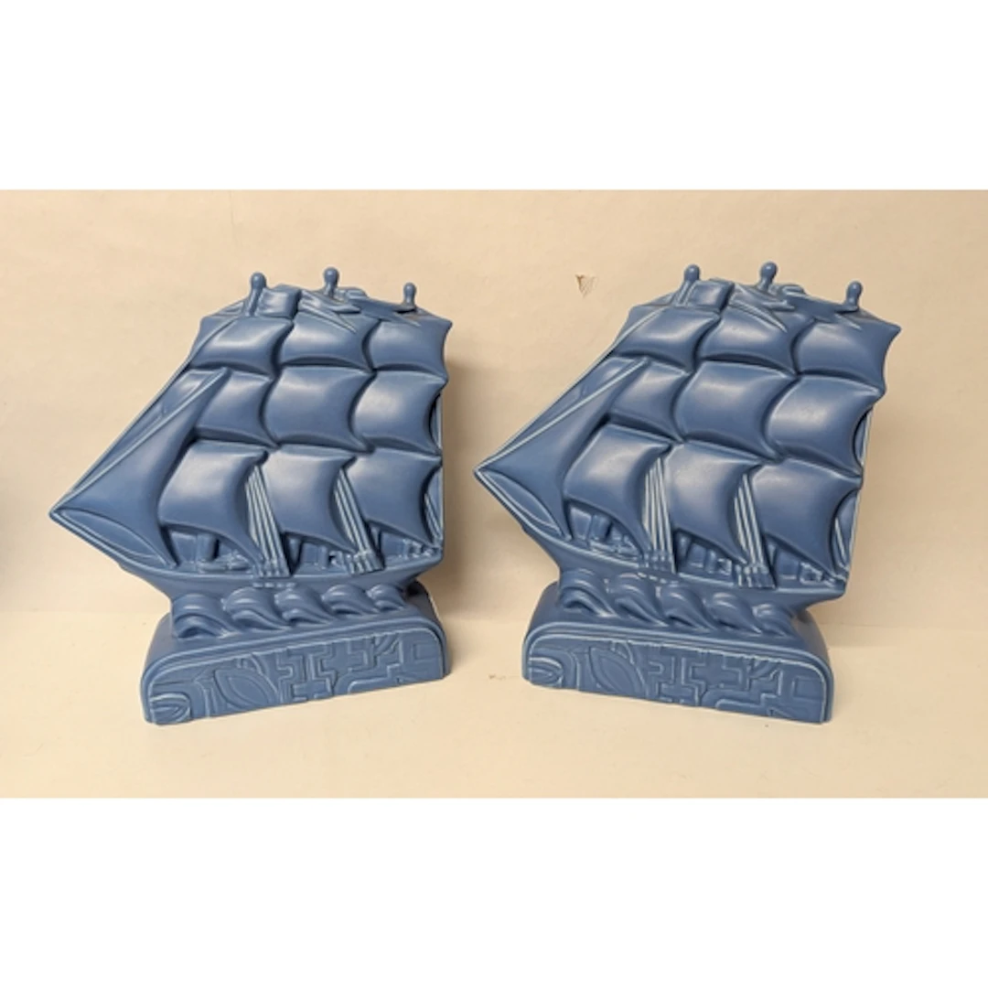 A pair of modern Poole Studio blue sprayed Galleon bookends