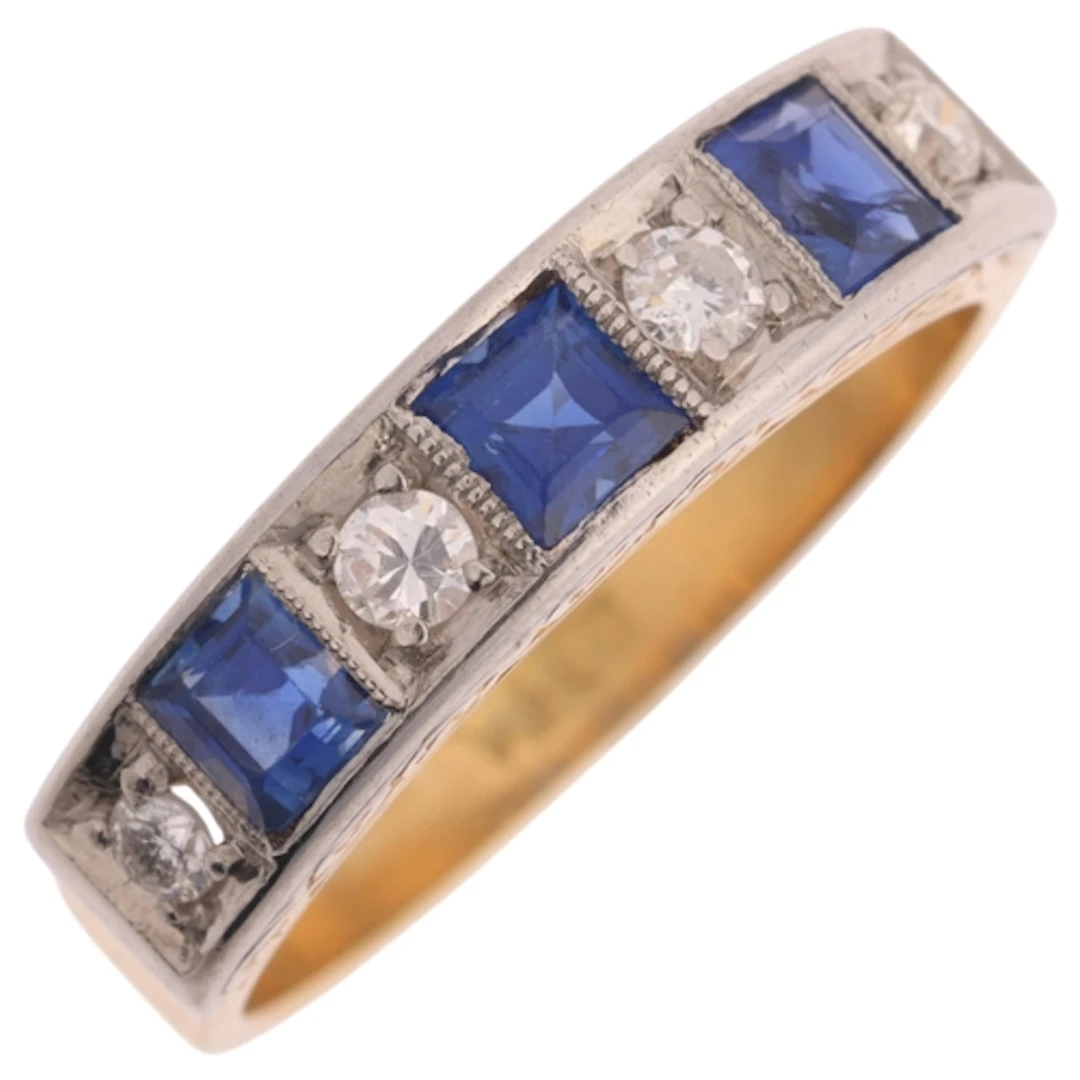 An 18ct gold sapphire and diamond half eternity ring, set wi...