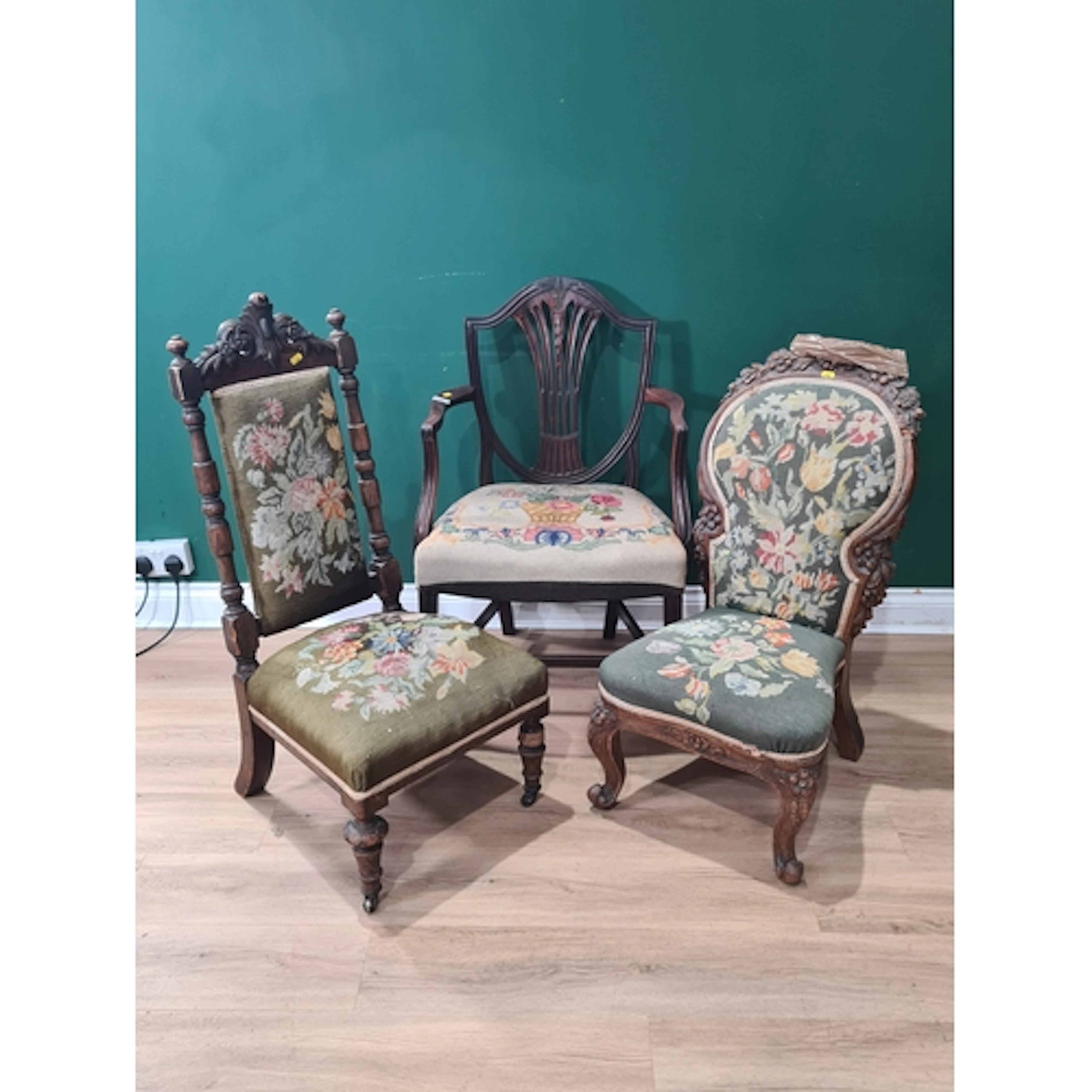 A carved nursing Chair with floral upholstered seat a carved...