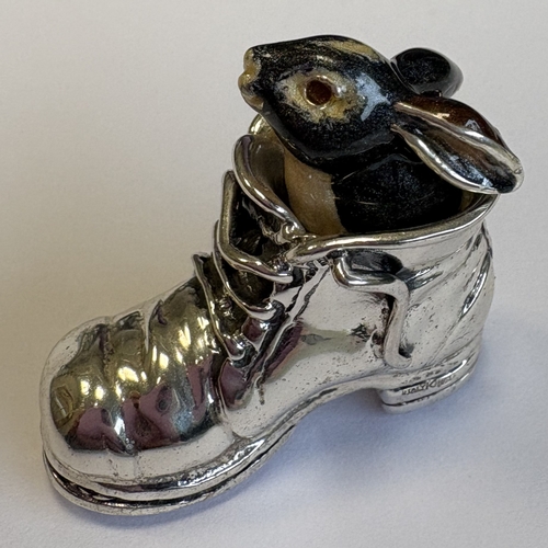 A novelty silver and enamelled figure of a rabbit in a boot....