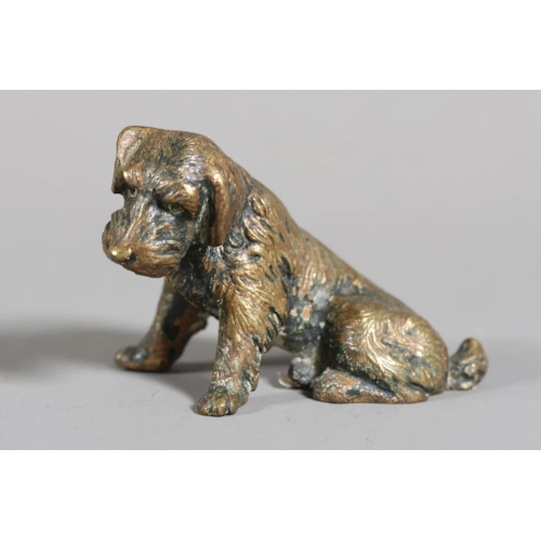 Cold painted bronze of a dejected dog.