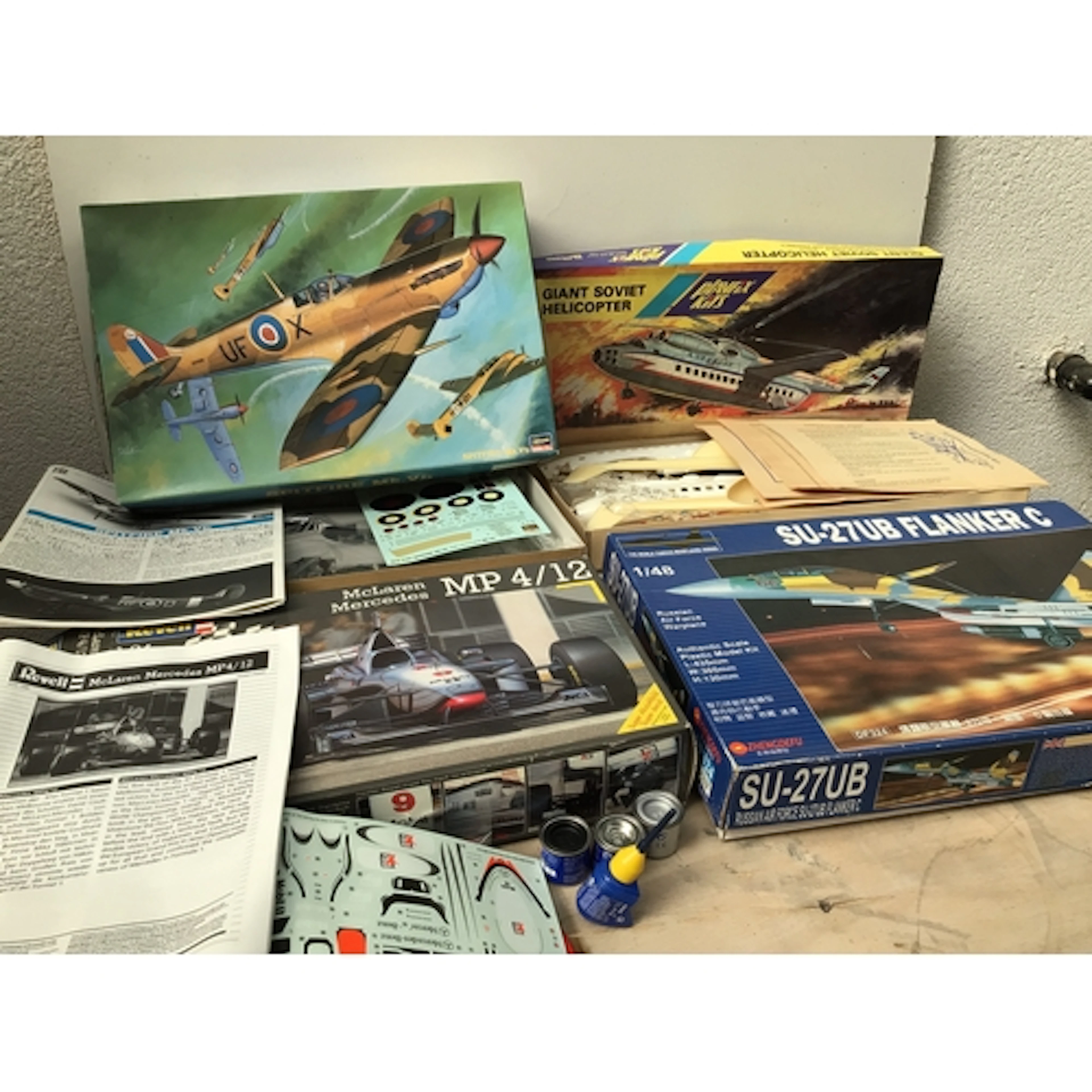 A bag containing boxed model kits by various manufacturers i...