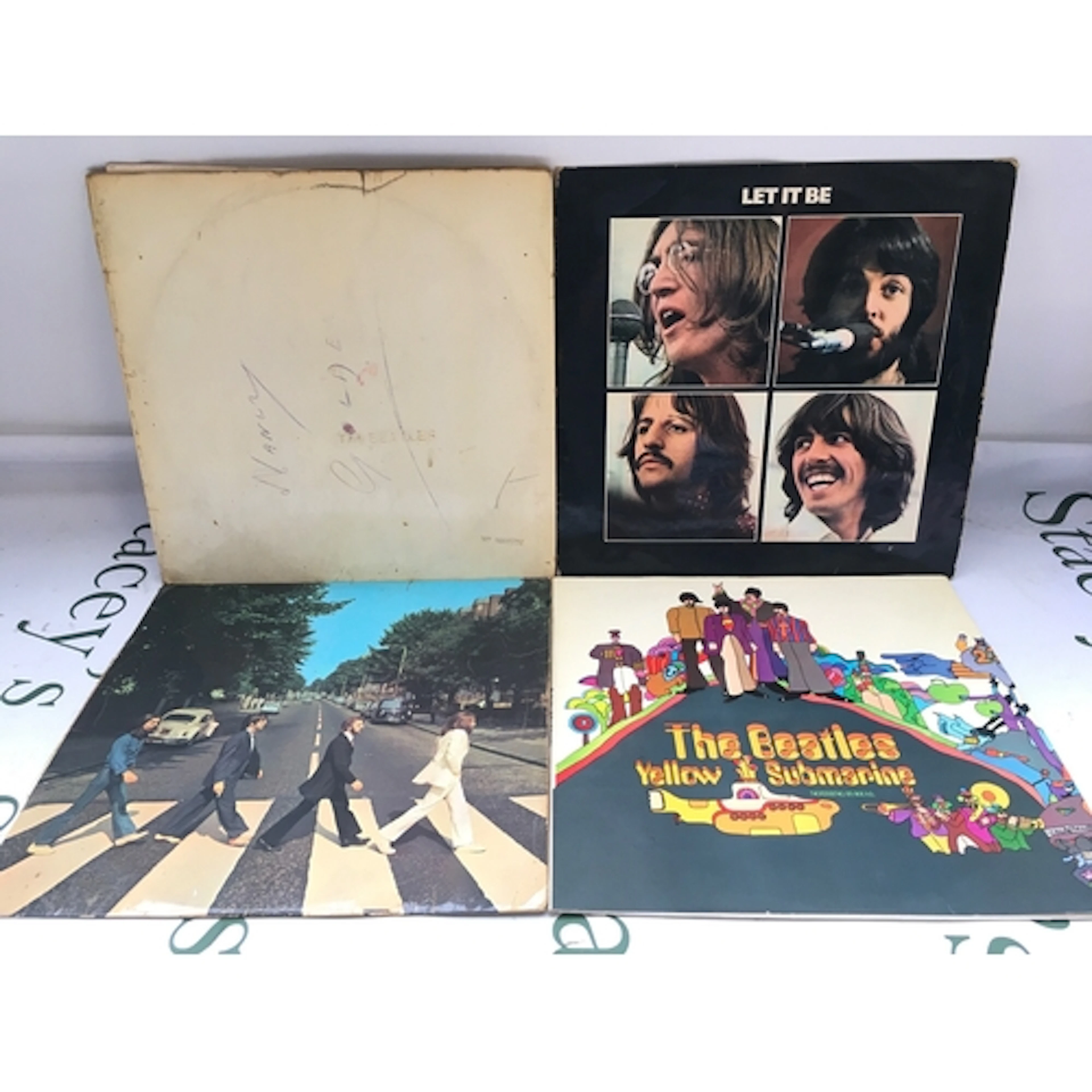 Four Beatles LPs comprising an early numbered pressing of th...