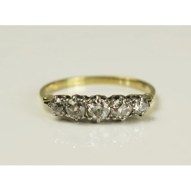 A diamond five stone ring in a high carat precious yellow me...